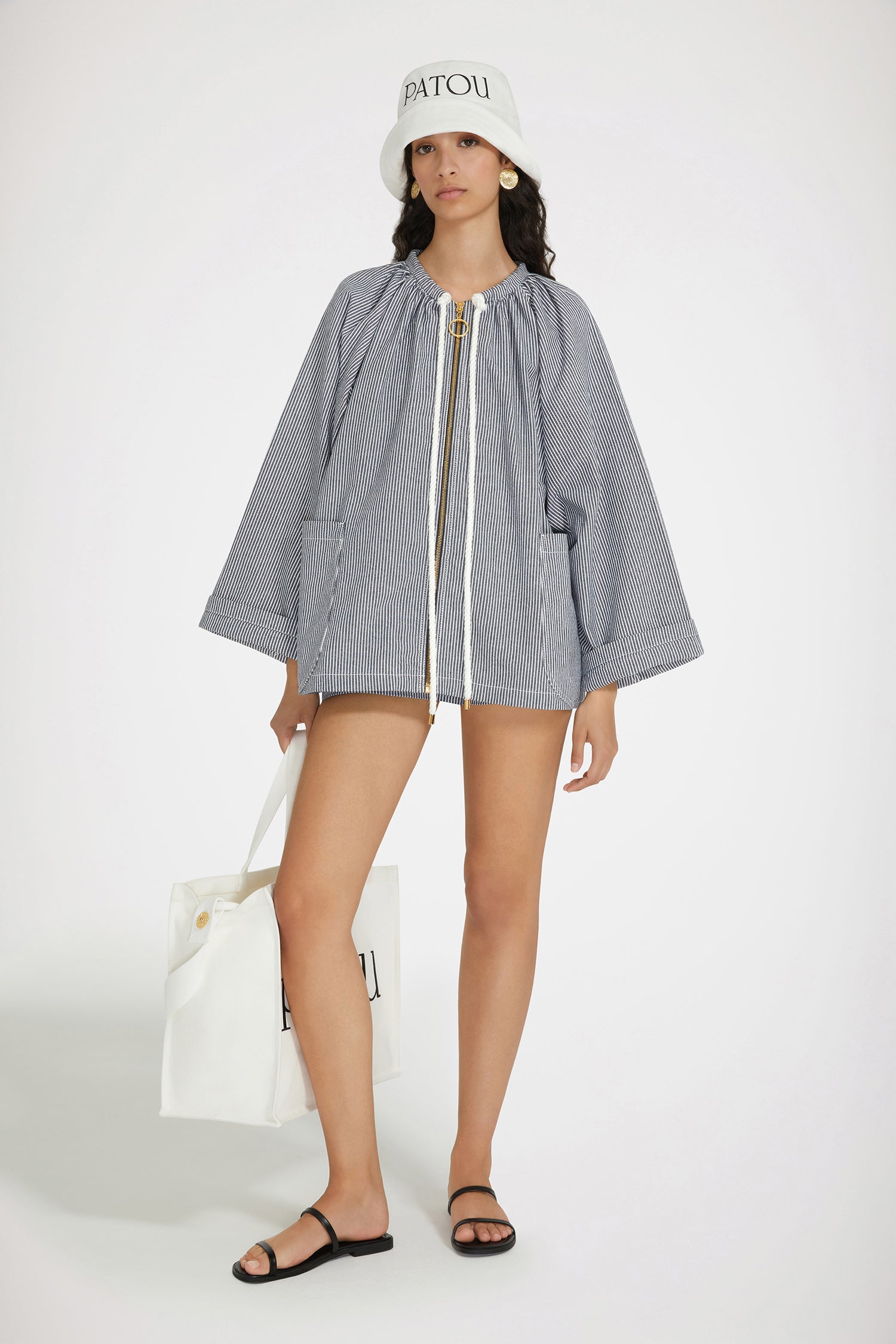 Patou - Oversized sailor jacket in striped cotton denim - Navy Striped - Generous volumes and nautical details that are so very Patou.Navy cotton denim jacket. Thin stripes. Oversized silhouette. Gathered neck; braided rope drawstring with gold-tone Patou-engraved tips. Zip fastening. Large patch pockets. Patou embroidery at the front. Contrast topstitching.This style is oversized.