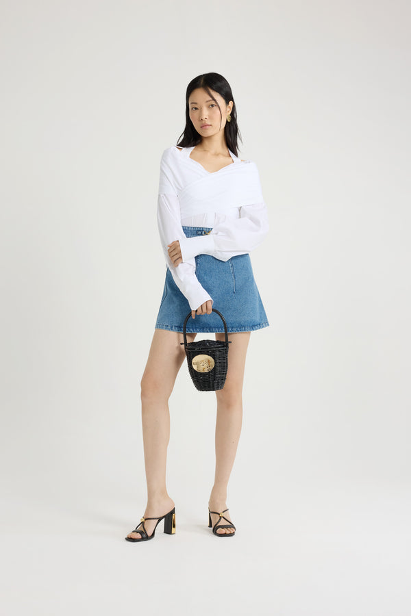 Patou - Jupe courte évasée en denim de coton - Heritage Blue Wash - Jupe en denim de coton délavé bleu héritage. Modèle court. Silhouette évasée. Médaillon doré amovible gravé avec le logo Patou sur le devant. Patou brodé à la taille. Poches sur le devant. Pinces sur le devant et au dos. Fermeture par zip au dos.Ce modèle est ajusté à la taille.