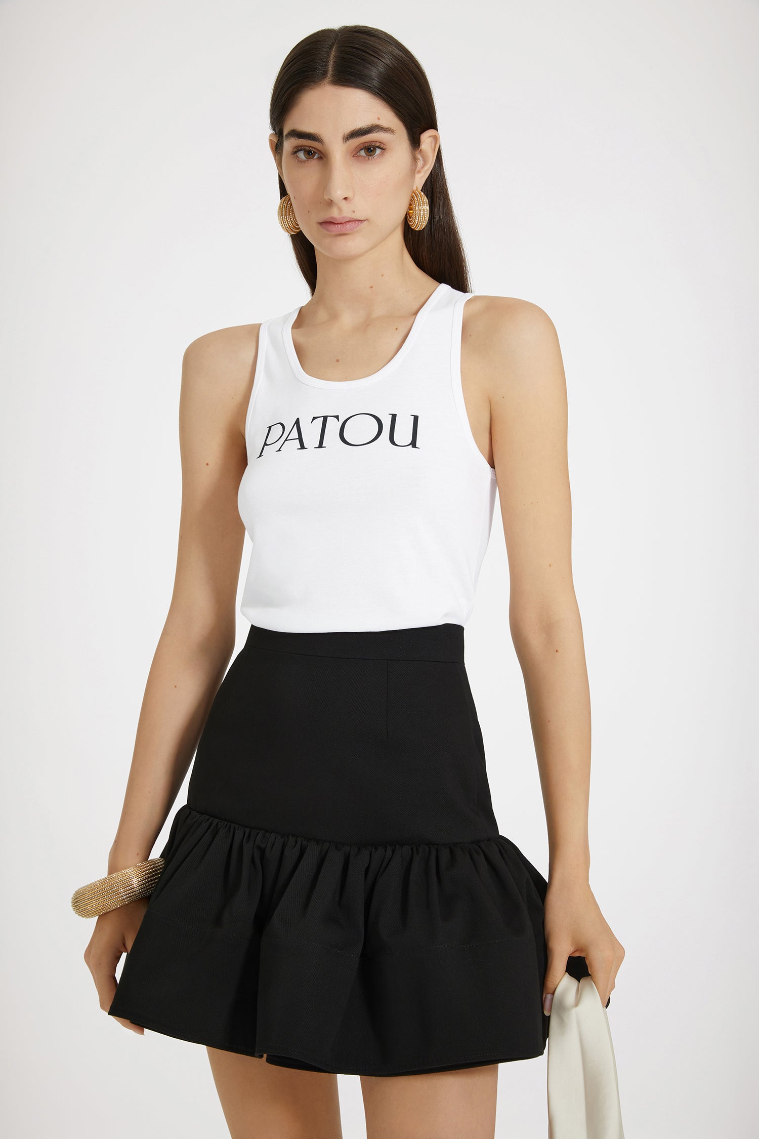 Patou - Ruffle mini skirt in cotton gabardine - Black - A mini skirt with a major silhouette.Black cotton gabardine skirt. High waist. Short length. Fit and flare silhouette with maxi ruffle at the hem. Zip fastening at the back. Darts at the front and back.