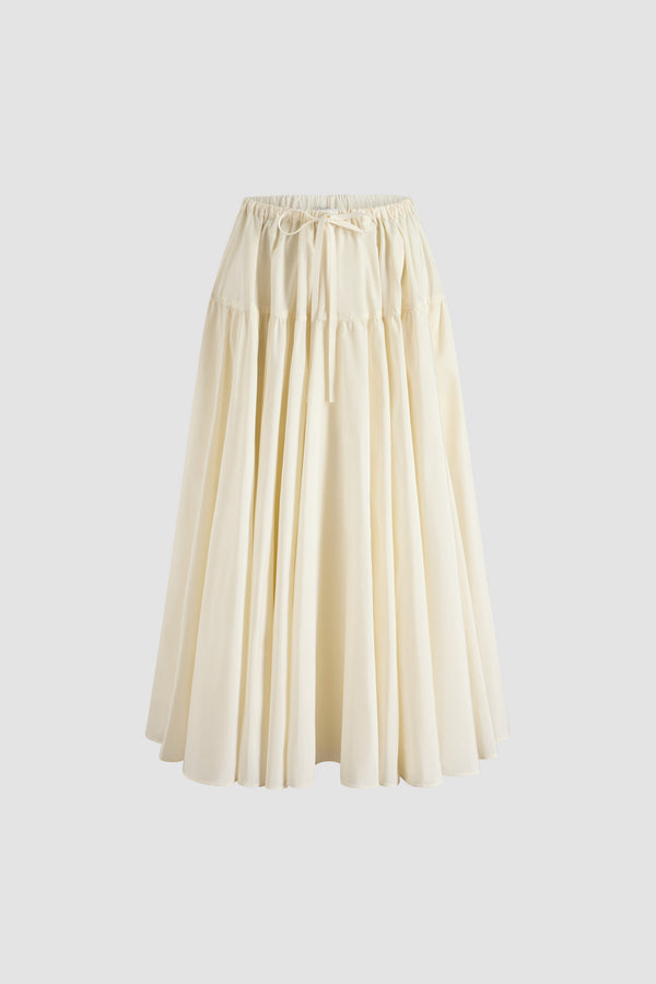 Patou - Jupe longue volumineuse en faille recyclée - Ivory - Jupe en faille recyclée ivoire. Longueur cheville. Construction à étages. Taille élastiquée à coulisse en gros-grain. Poches latérales.