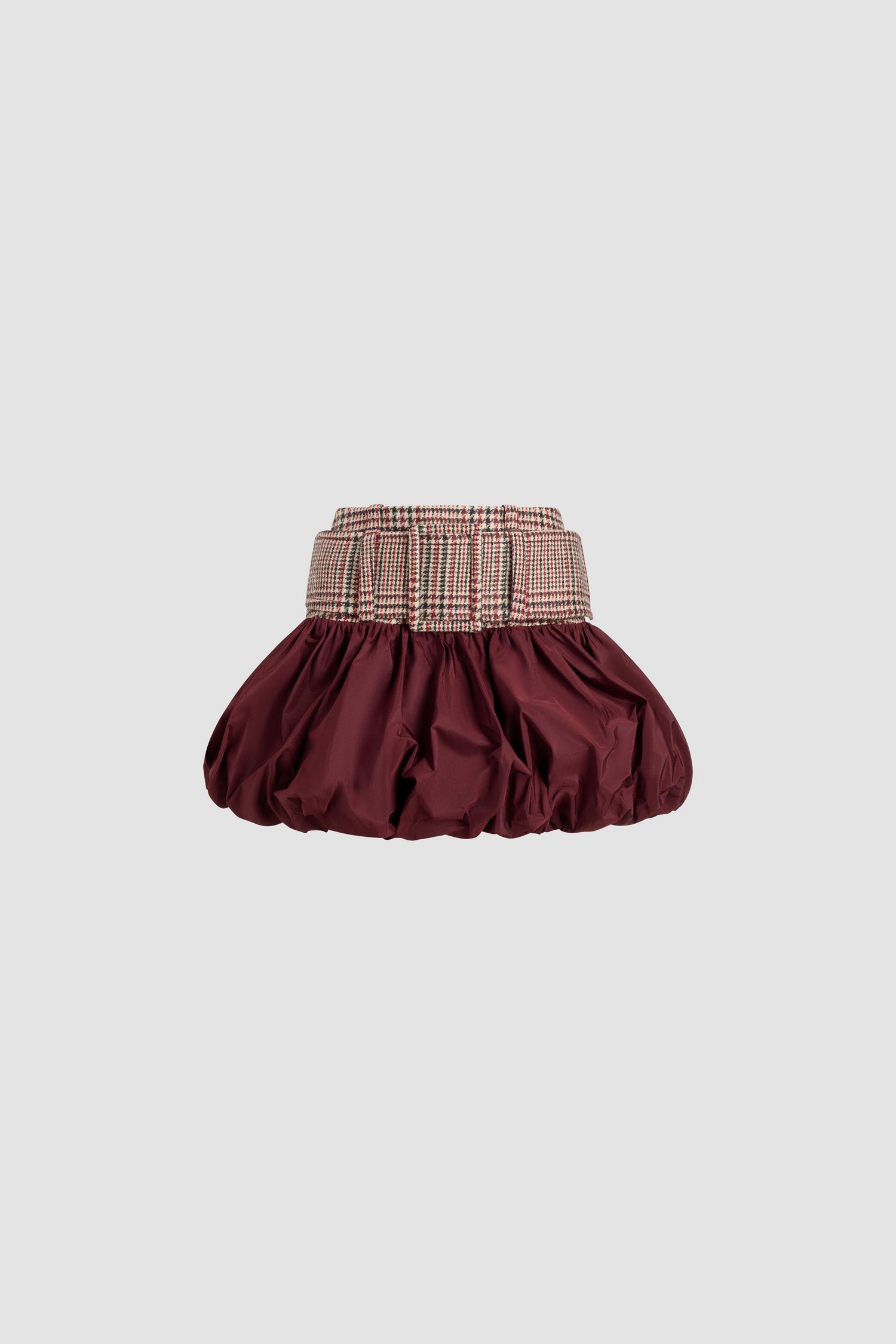 Patou - Belted bubble mini skirt in sustainable wool flannel and faille - Prince Of Wales - Burgundy polyester faille skirt. Contrast waistband in sustainable virgin wool flannel with a Prince of Wales pattern. Short length. Low waist. High volume silhouette that can be puffed out. Wide fabric belt with fabric-covered buckle. Zip fastening at the back.