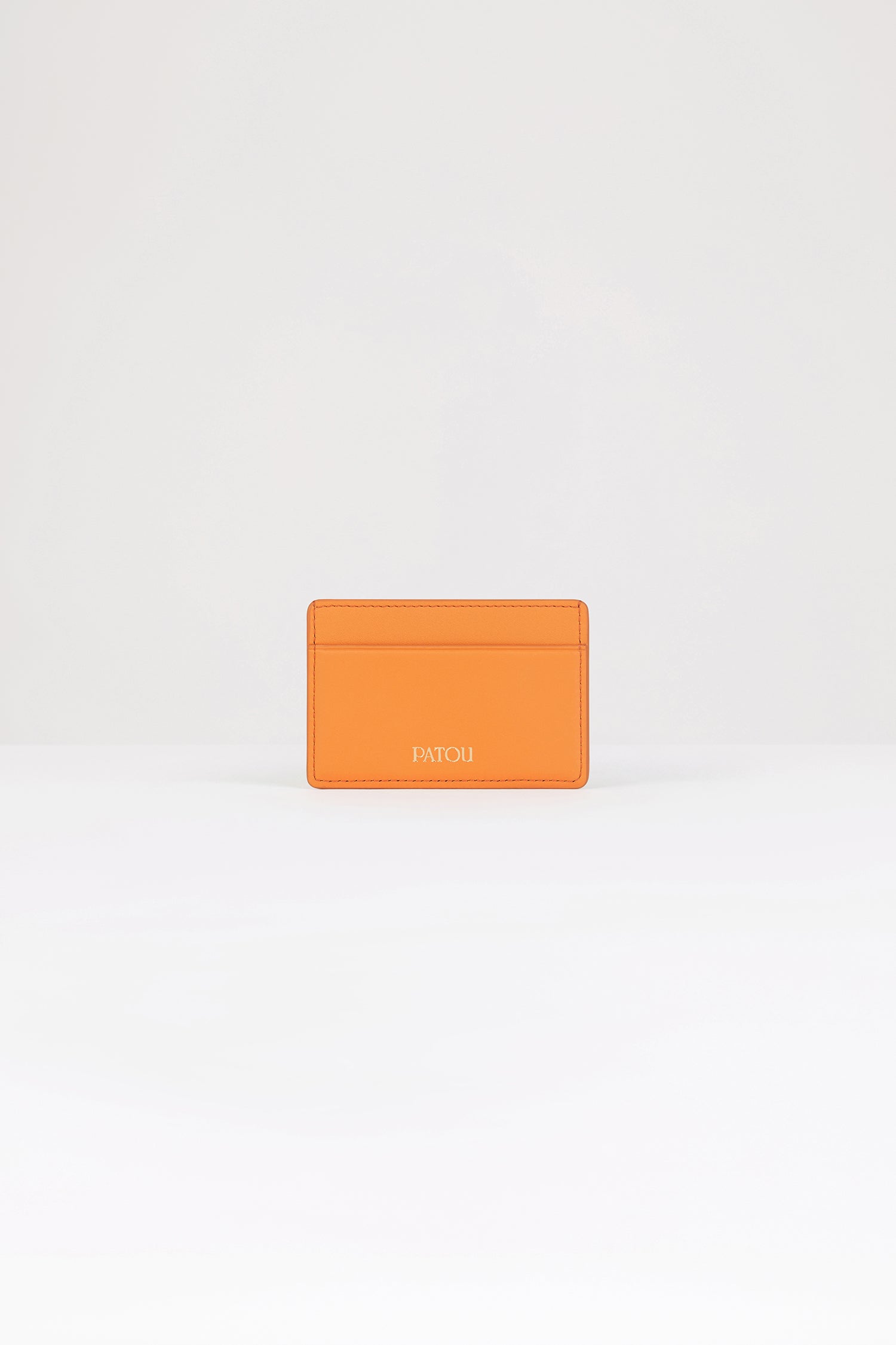 Patou - JP cardholder in leather - Bright Orange - A small piece of Patou for your everyday.Bright orange leather cardholder. Crafted using unique materials sourced from unused high-quality leather hides. Two card slots, central compartment. Gold embossed Patou at the front, cut-out at the back.