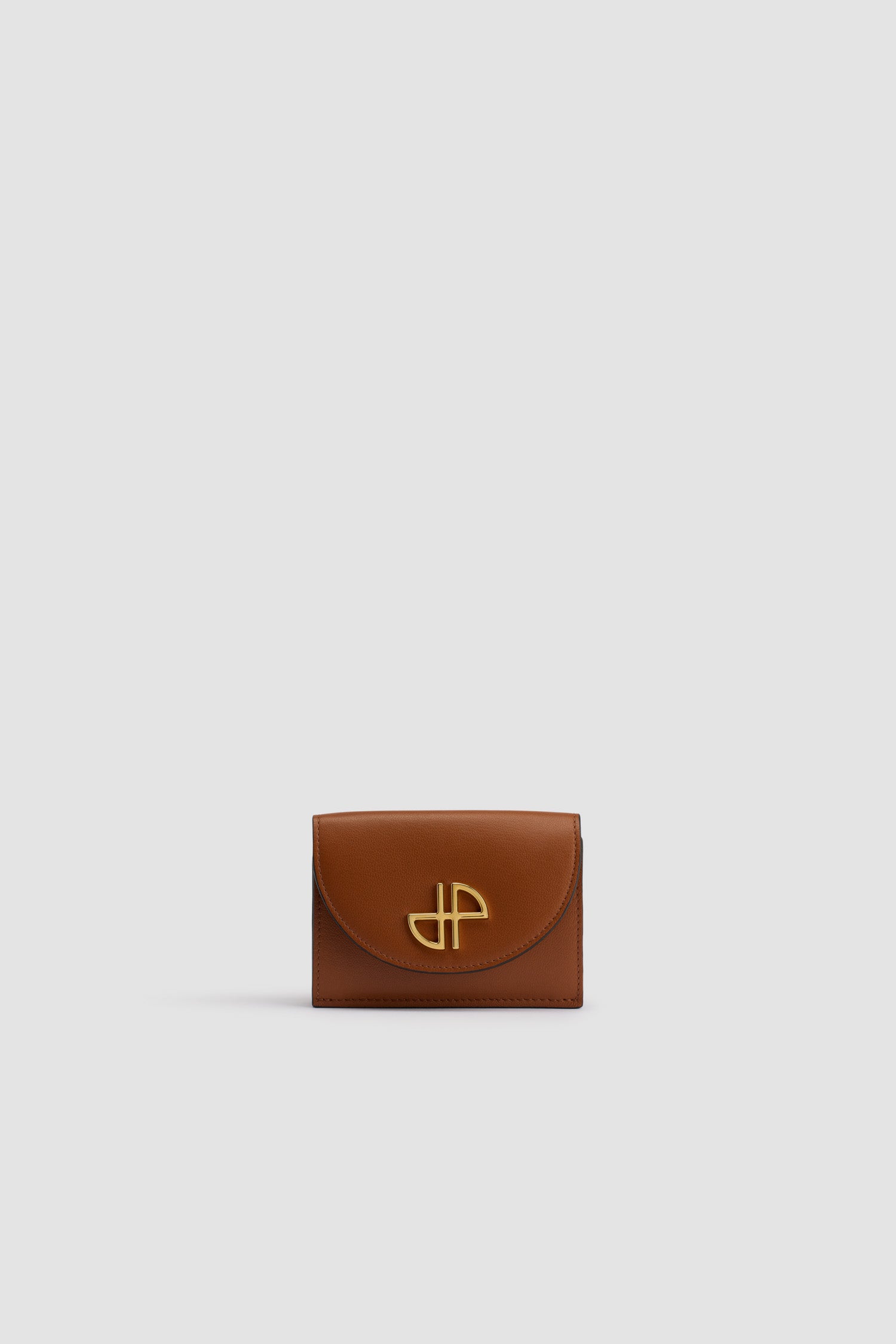 Patou - JP wallet in leather - Autumn Leaf - Autumn Leaf brown leather wallet. Gold-tone JP at the front. Snap button fastening. Multiple card slots and pockets, one large pocket for notes. JP cut-out and gold embossed Patou inside.