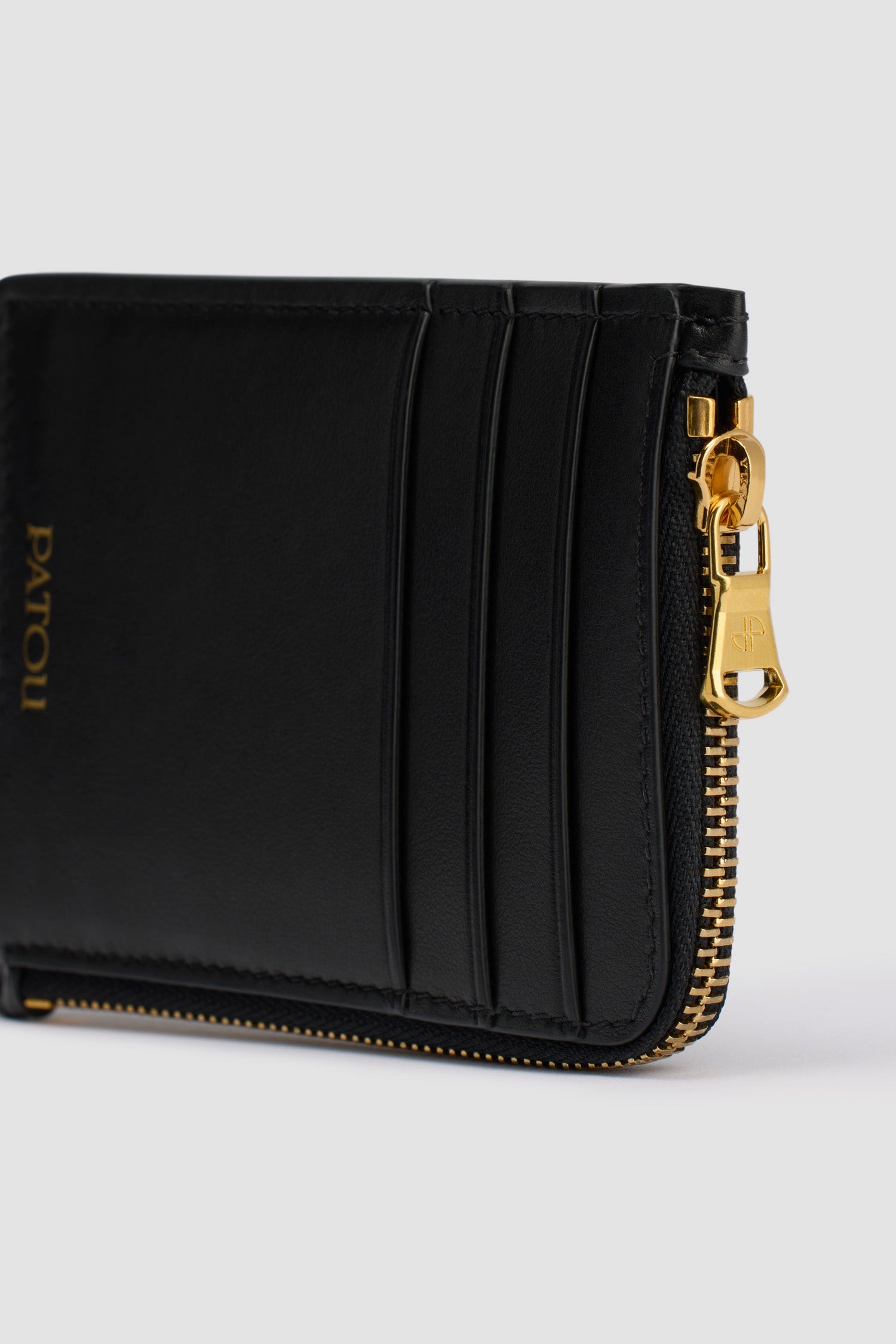 Patou - Patou coin cardholder in leather - Black - Black leather coin cardholder. Crafted using unique materials sourced from unused high-quality leather hides. Three card slots at the front, one cut-out card slot at the back. Zipped coin cardholder. Gold embossed Patou.