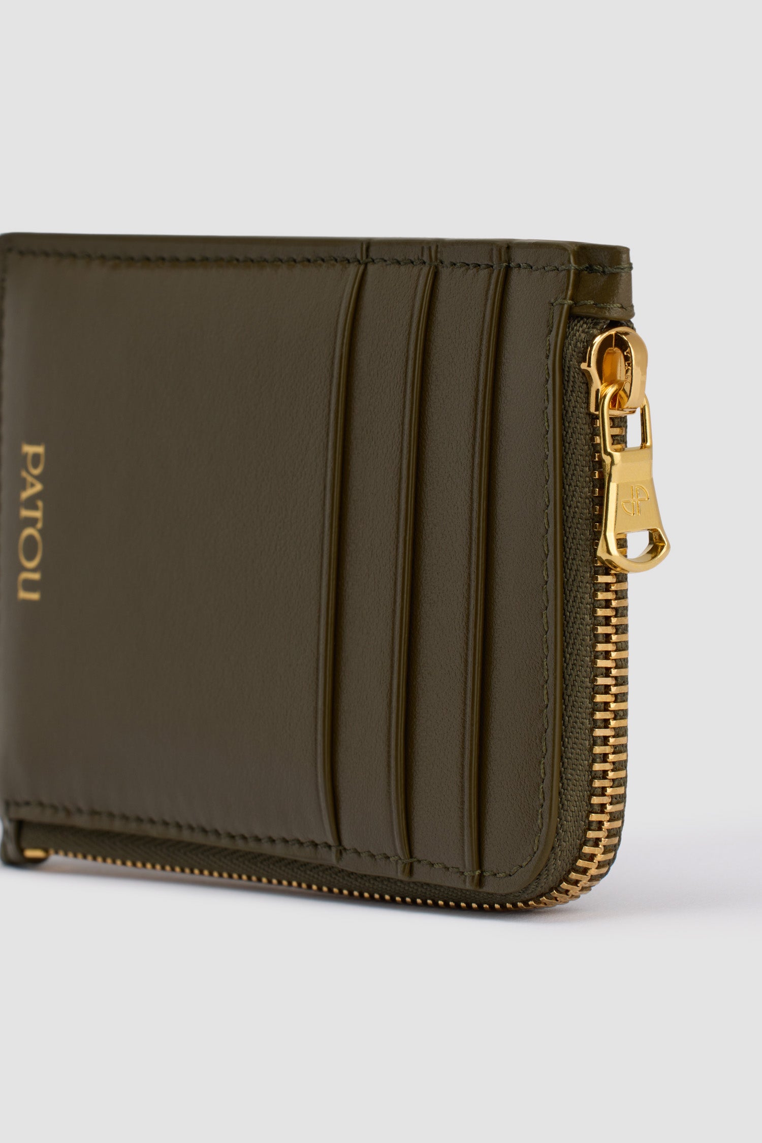 Patou - Patou coin cardholder in leather - Winter Moss - Winter Moss green leather coin cardholder. Three card slots at the front, one cut-out card slot at the back. Zipped coin cardholder. Gold embossed Patou.