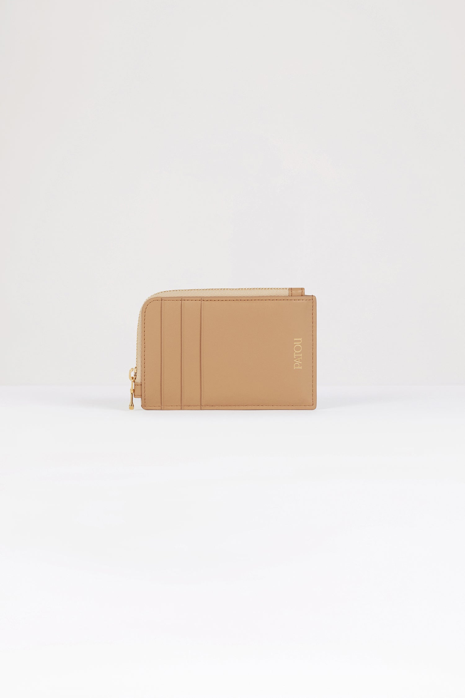 Patou - Patou coin cardholder in leather - Beige - The perfect Patou purse.Beige leather coin cardholder. Three card slots at the front, one cut-out card slot at the back. Zipped coin cardholder. Gold embossed Patou.
