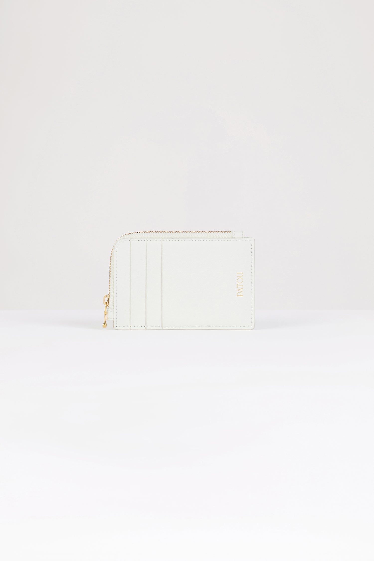 Patou - Patou coin cardholder in leather - White - The perfect Patou purse.White leather coin cardholder. Three card slots at the front, one cut-out card slot at the back. Zipped coin cardholder. Gold embossed Patou.