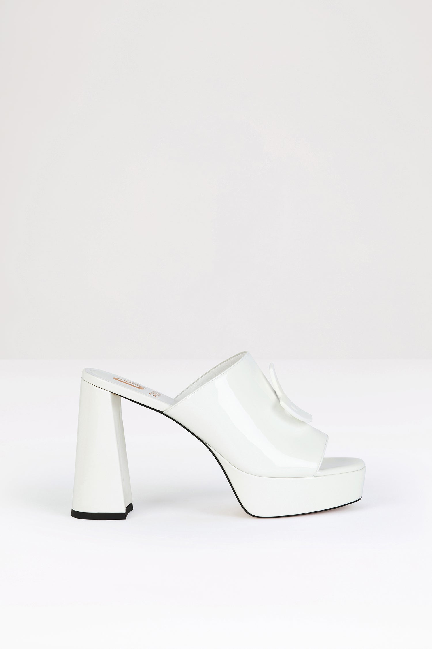 Patou - GLOSSY ANITA x Bettina Vermillon - White - A mule fit for a muse.White patent leather mules. From a special collaboration with Paris-based shoemaker Bettina Vermillon. Quilted upper with JPBV appliqué. 11 cm block heel.