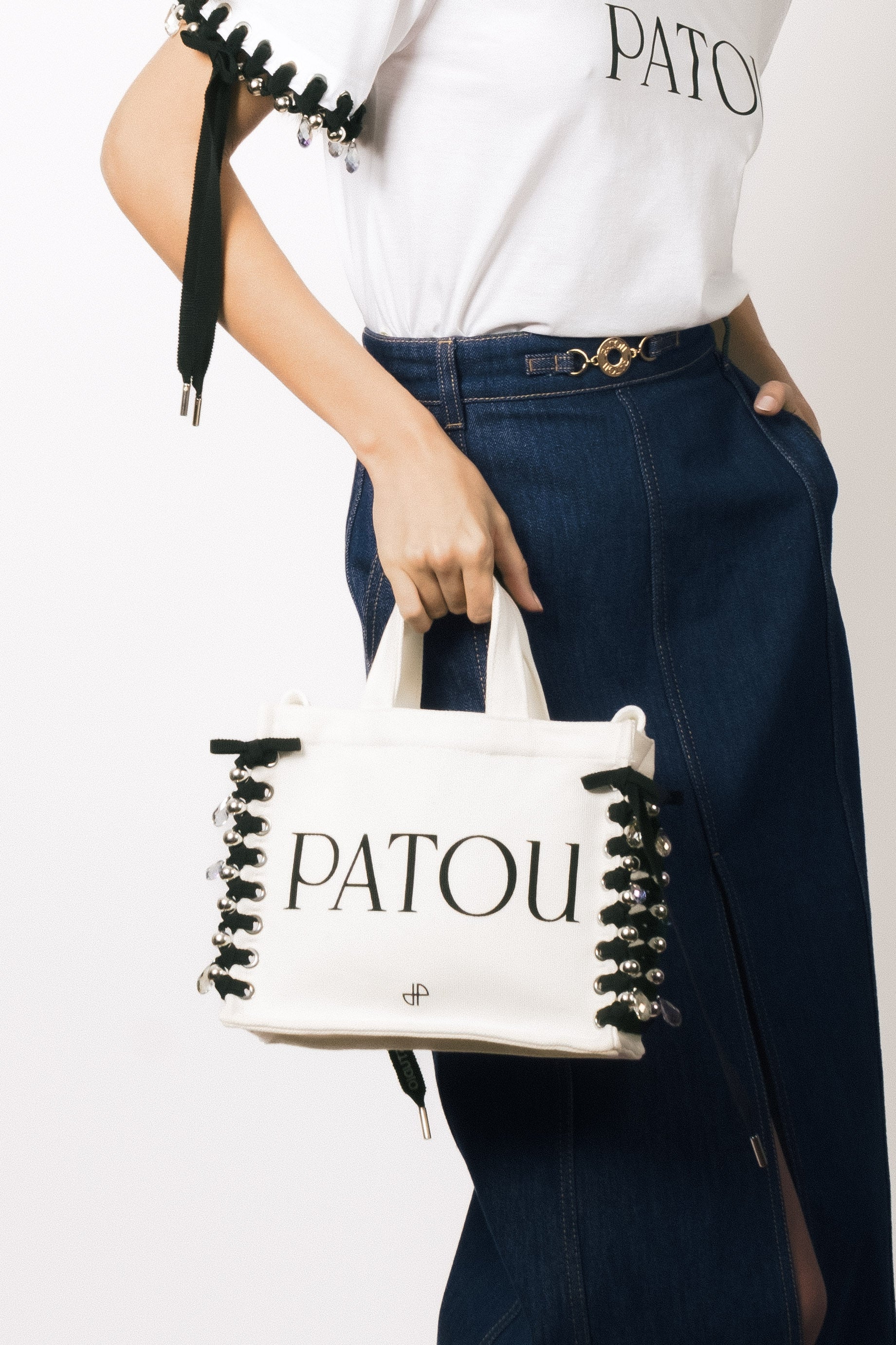 Patou - Patou Upcycling canvas tote in organic cotton - Black - For its inaugural edition, Patou partners with French designer Kitesy Martin, founder of Kitesy Martin Studio.Cream organic cotton tote. Patou lettering logo and JP monogram in black. White embossed shoulder strap with gold buttons. Two top handles. Can be carried by hand or on the shoulder.Limited Edition.