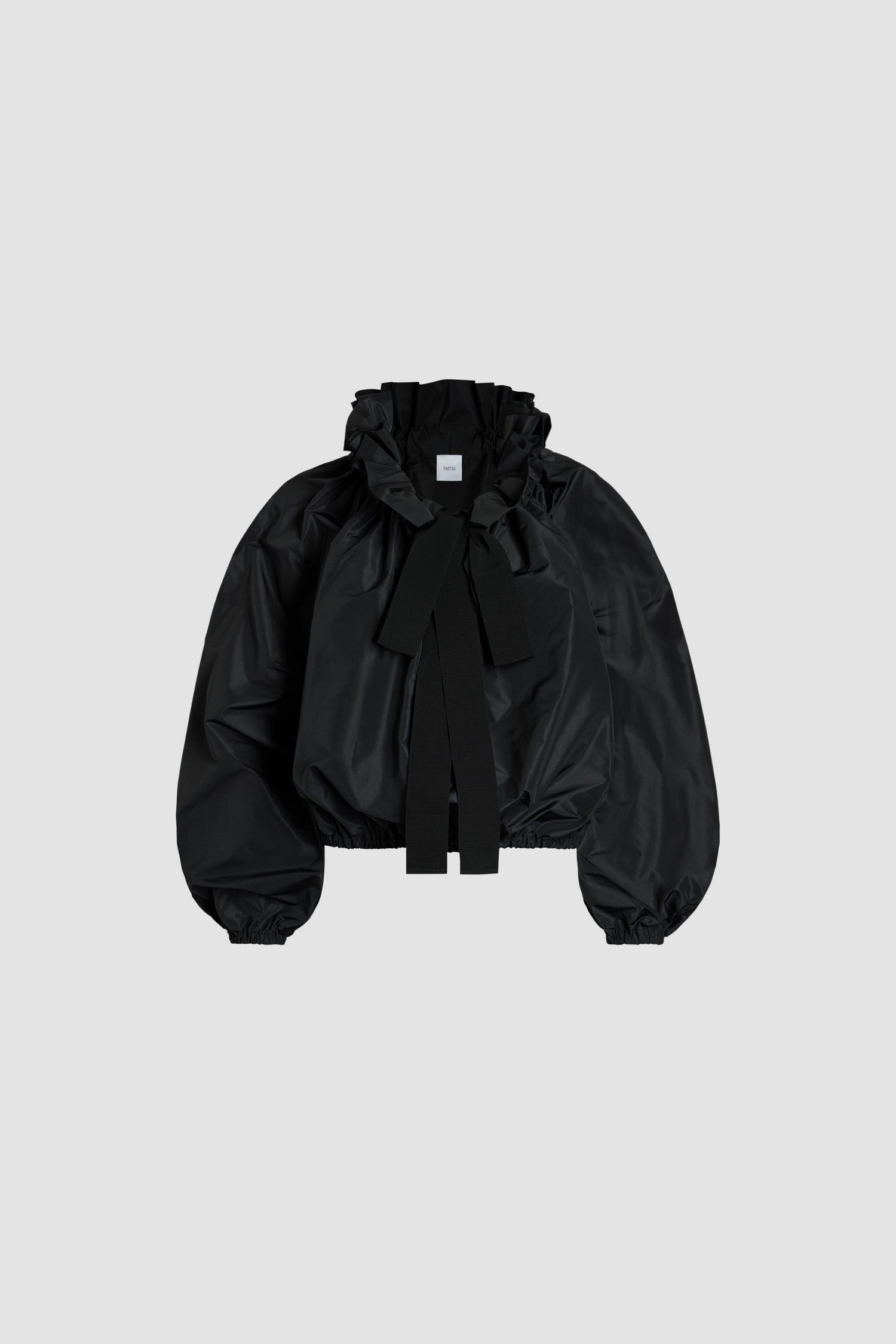 Patou - La Patou Blouse in recycled faille - Black - An everyday proposition of bold sleeves and couture ribbons.Black recycled polyester faille top. High volume silhouette. Drawstring collar with ruching and grosgrain. Batwing sleeves with elasticated cuffs. Elasticated waist.