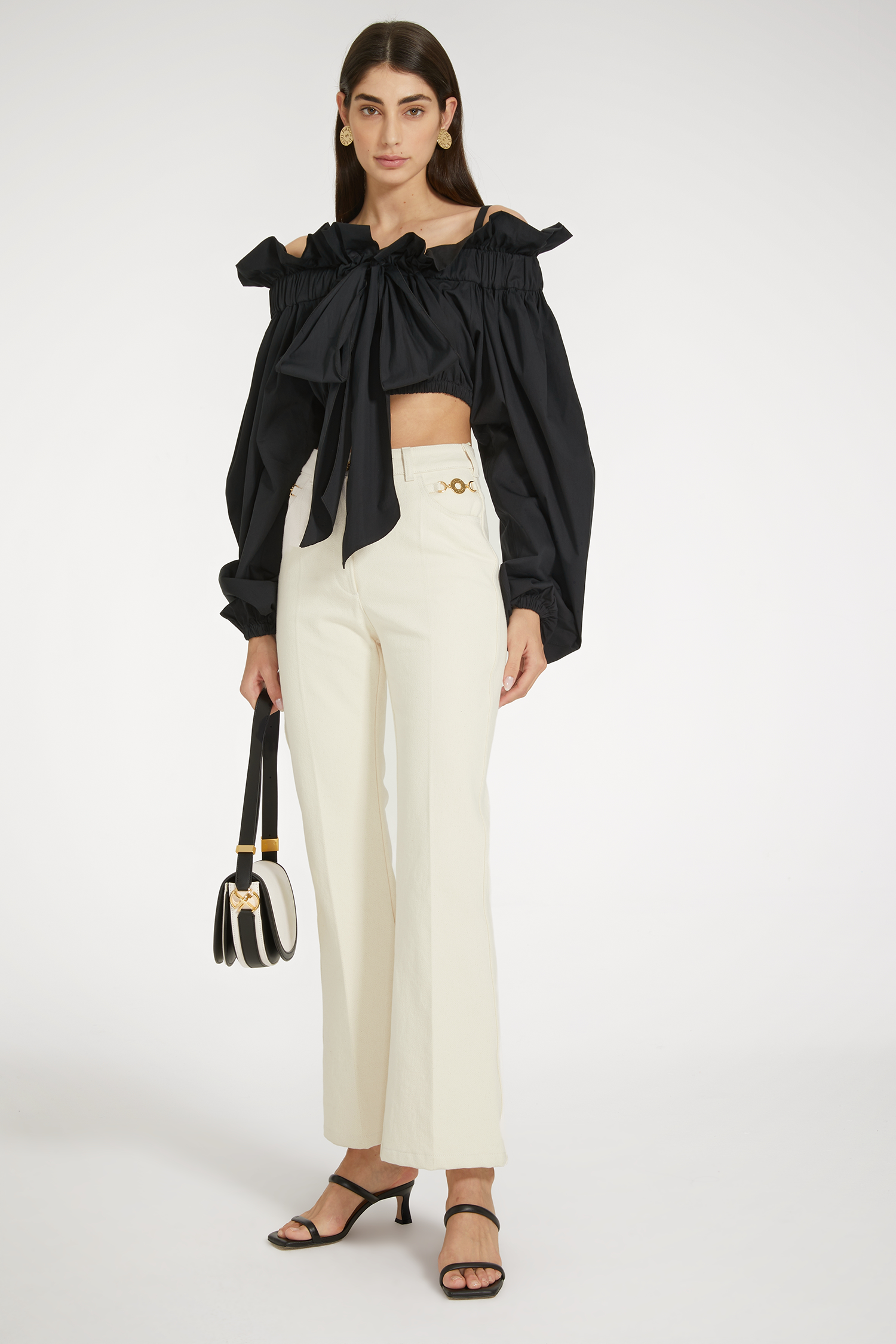Patou - Cropped drawstring top in sustainable cotton - Black - A cropped variation on a Patou icon.Black sustainable cotton poplin top. Cropped high volume silhouette that can be worn knotted at the neck or off the shoulders. Drawstring collar with flounce at the front and long grosgrain ties. Batwing sleeves with elasticated cuffs. Elasticated waist.This is a cropped style with high volume sleeves.
