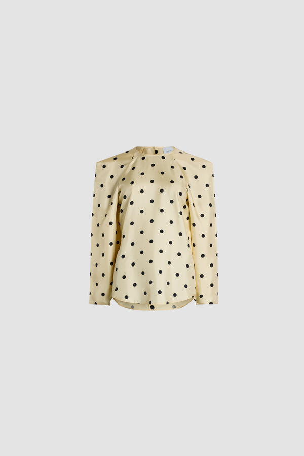 Patou - Top à épaules carrées en soie bio imprimée - Angora Dots - Top en soie bio blanc cassé. Imprimé pois. Col rond. Épaules carrées. Manches raglan. Boutonnage au dos et aux poignets.
