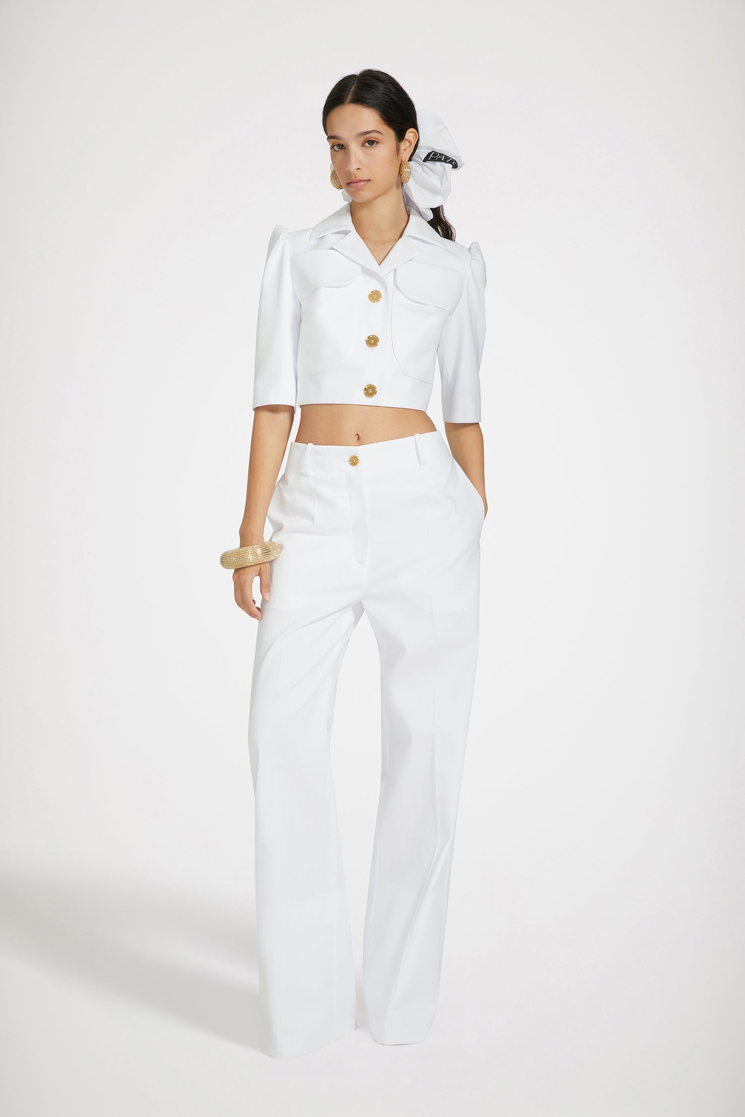 Patou - Iconic long trousers in cotton gabardine - White - Flawless tailoring with a smile: a life in Patou.White cotton gabardine trousers. Iconic Patou silhouette. Long straight fit. Fastens via a gold-tone JP-engraved button and concealed zip at the front. Belt loops, two pockets at the sides. Signature darts at the back.