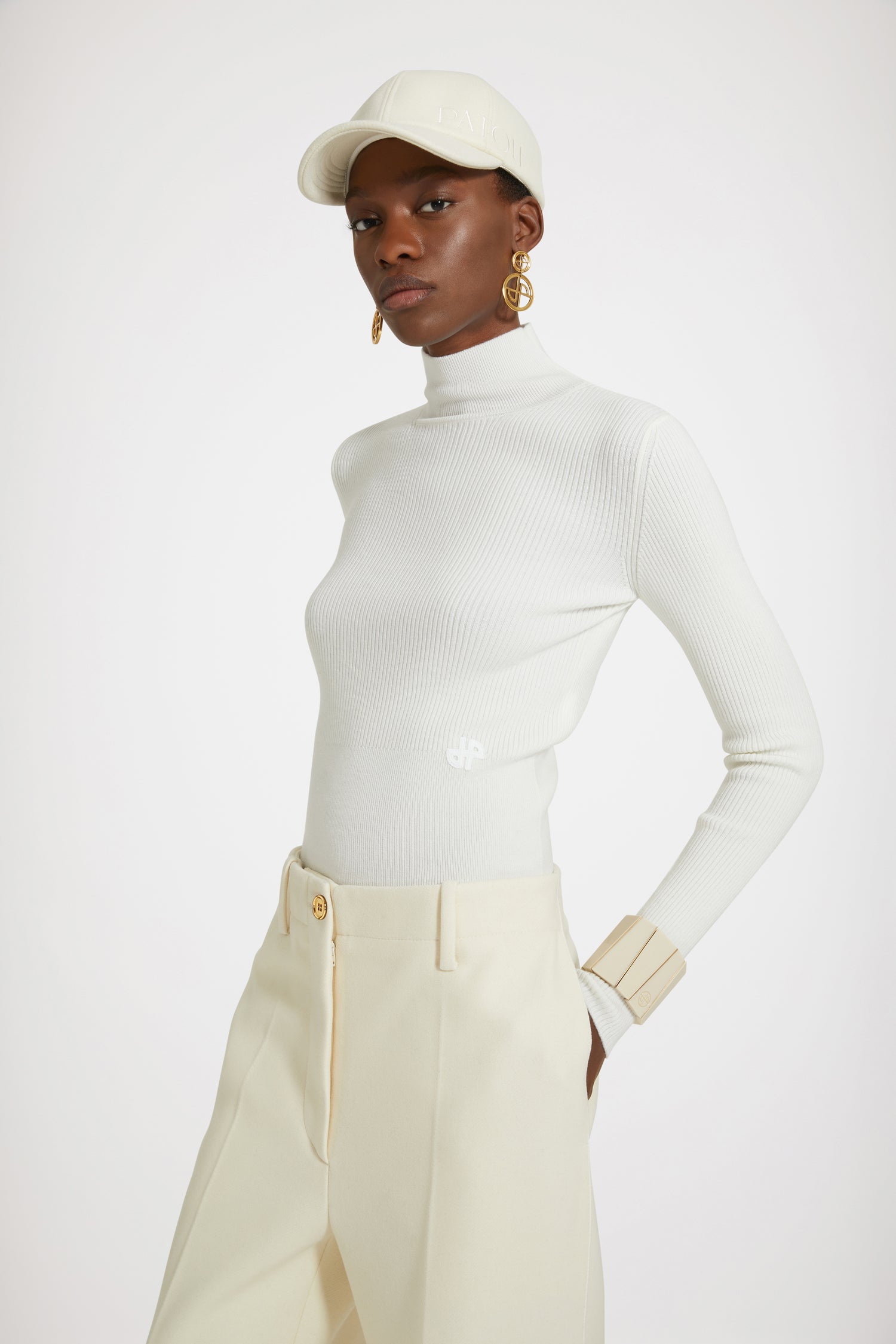 Patou - Iconic long trousers in wool-blend felt - Avalanche - Flawless tailoring with a smile: a life in Patou.Avalanche white wool-blend felt trousers. Iconic Patou silhouette. Long straight fit. Fastens via a gold-tone JP-engraved button and concealed zip fly at the front. Belt loops, two pockets at the sides. Signature darts at the back.