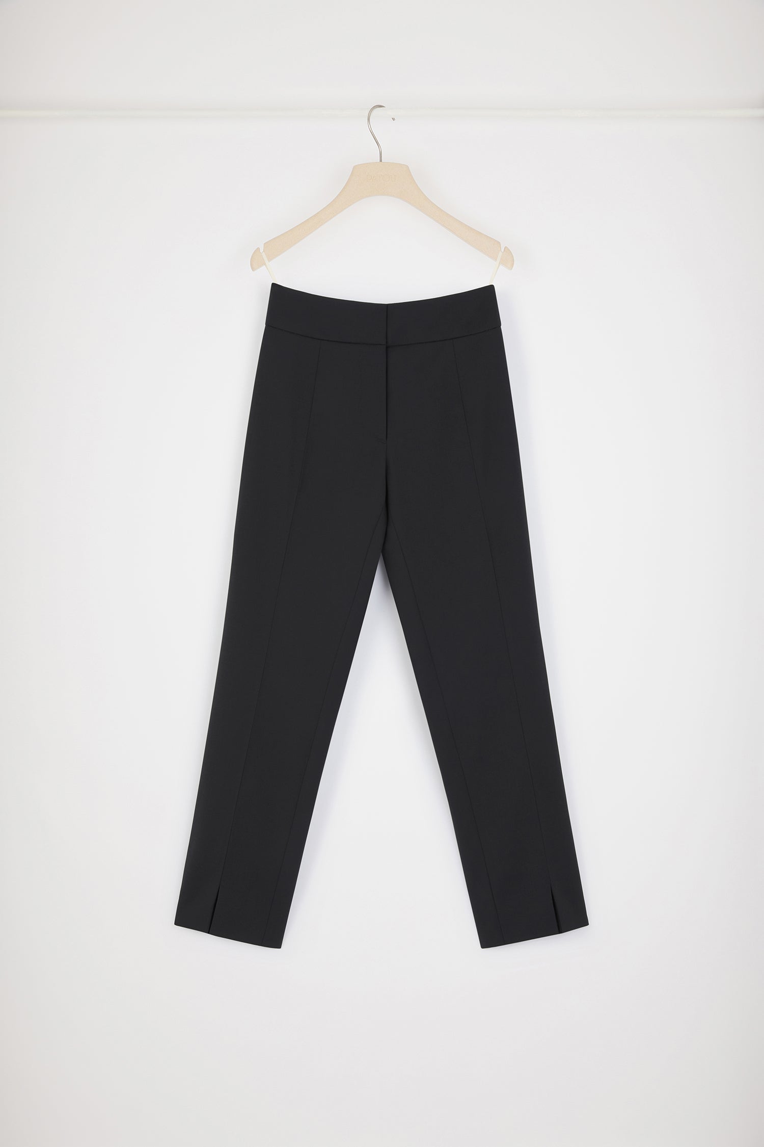 Patou - Tapered trousers in technical wool - Black - The perfect Patou proportions.Black technical wool twill trousers. Tapered leg. Mid rise. Slim fit. Concealed hook and zip fly. Pressed creases at the front and back. Split-front hems.
