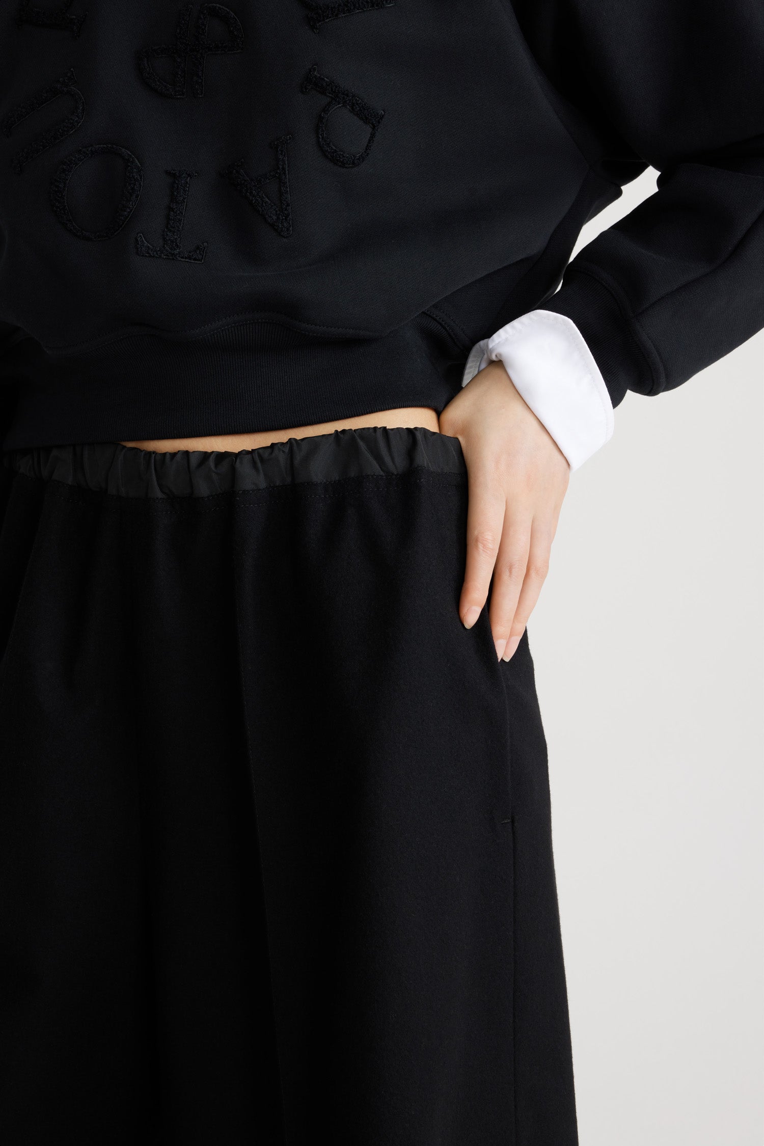 Patou - Lang geschnittene Shorts aus nachhaltiger Wollmischung - Black - Schwarze Flanellshorts aus nachhaltiger Wollmischung. Knielang. Elastischer Taillenbund. Kontrastierender Bund. Zwei Seitentaschen. Bügelfalten auf der Vorderseite.