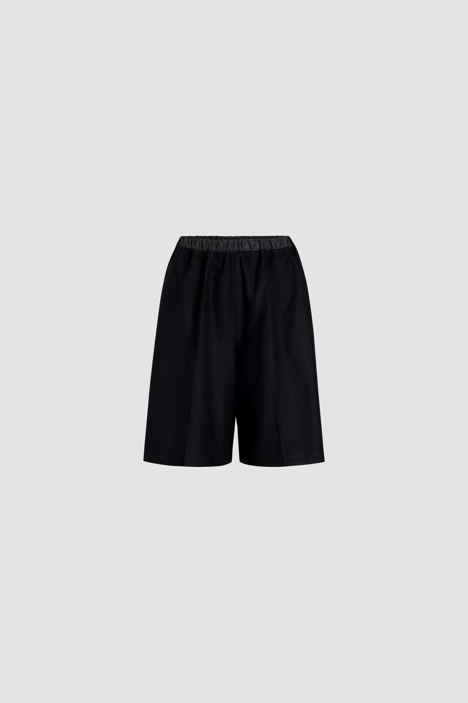 Patou - Lang geschnittene Shorts aus nachhaltiger Wollmischung - Black - Schwarze Flanellshorts aus nachhaltiger Wollmischung. Knielang. Elastischer Taillenbund. Kontrastierender Bund. Zwei Seitentaschen. Bügelfalten auf der Vorderseite.