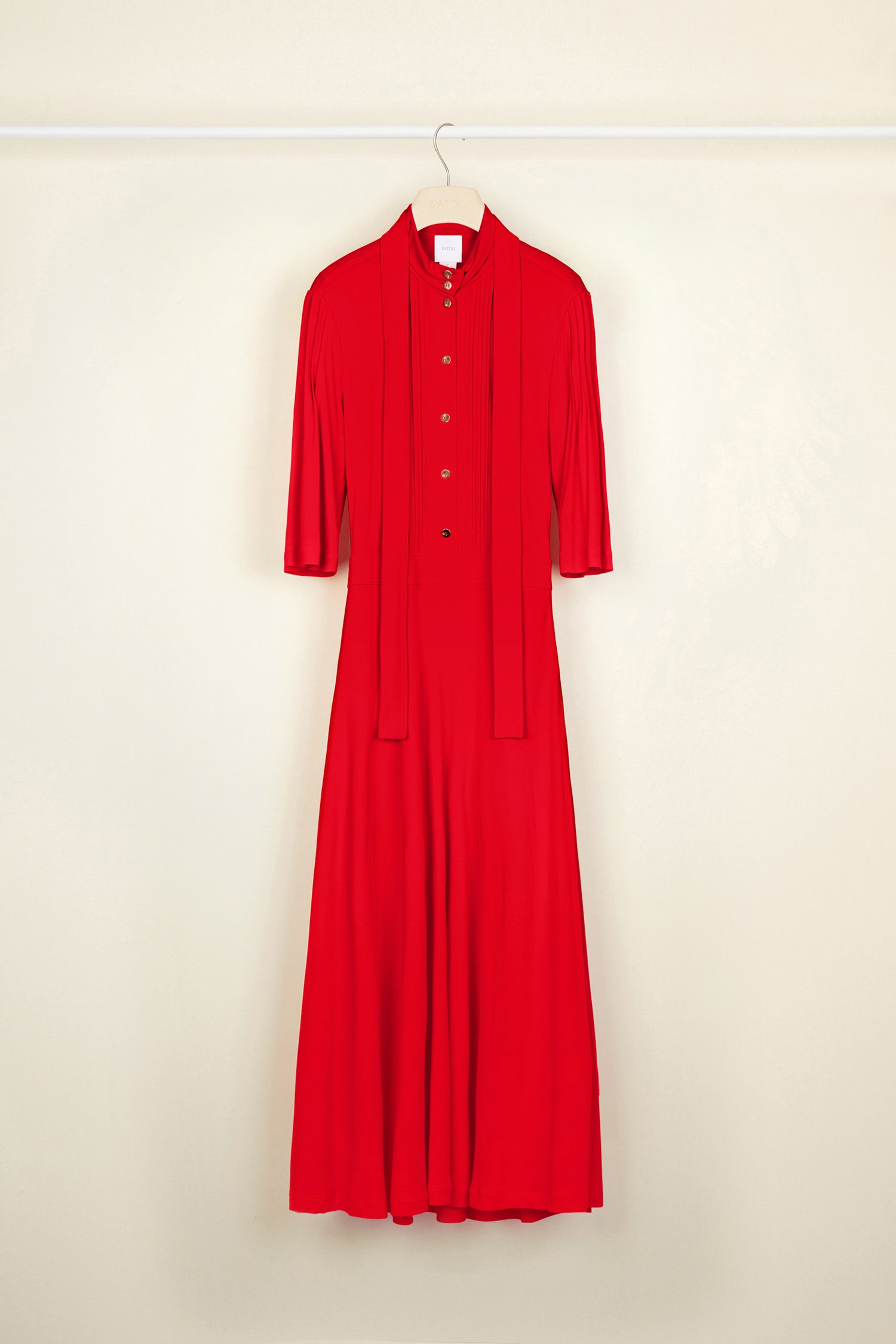 Patou - Necktie midi dress - Poppy - Pleats and ties and gold accents.Poppy red jersey dress. High collar with long ties around the neck. Micropleating down the bodice. Gold-coloured buttons at the front. Cropped sleeves. Midi skirt with pockets and buttons at the sides. Side pockets. Concealed side zip.