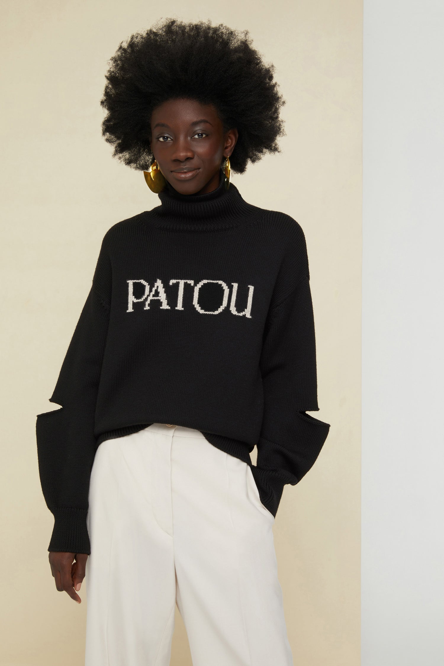 Patou - Oversized cut-out Patou jumper - Black - Patou, always and everyday.Black wool turtleneck jumper. Oversized silhouette. Lettering logo on the front in contrasting white. Cut-out elbows. Ribbed collar, cuffs and hem.