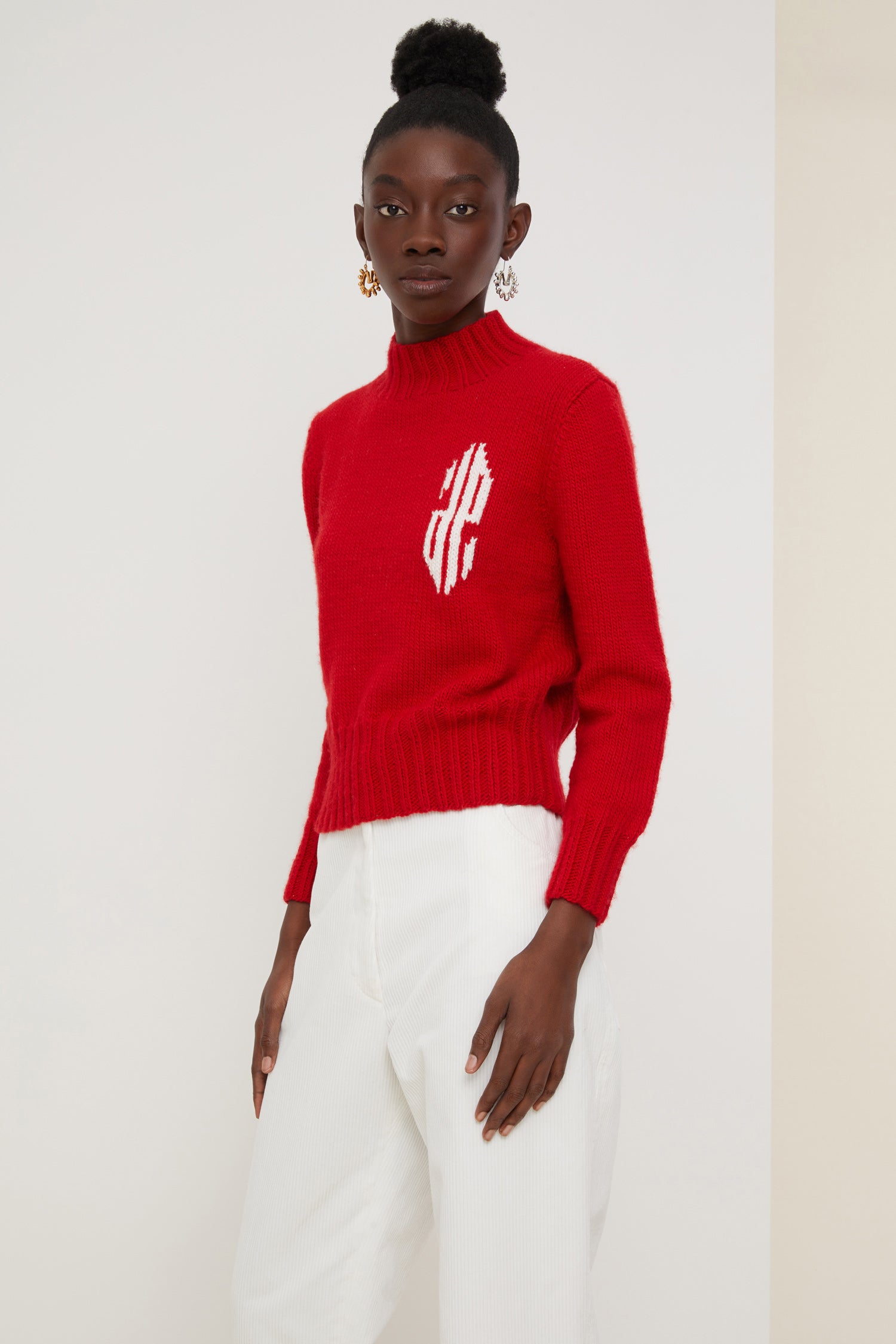 Patou - Cropped intarsia logo jumper - Poppy - A logo, a crest, a declaration of style.Poppy red wool jumper with intarsia logo on the chest in contrasting white. Cropped silhouette with a high neckline. Ribbed collar, cuffs and hem.