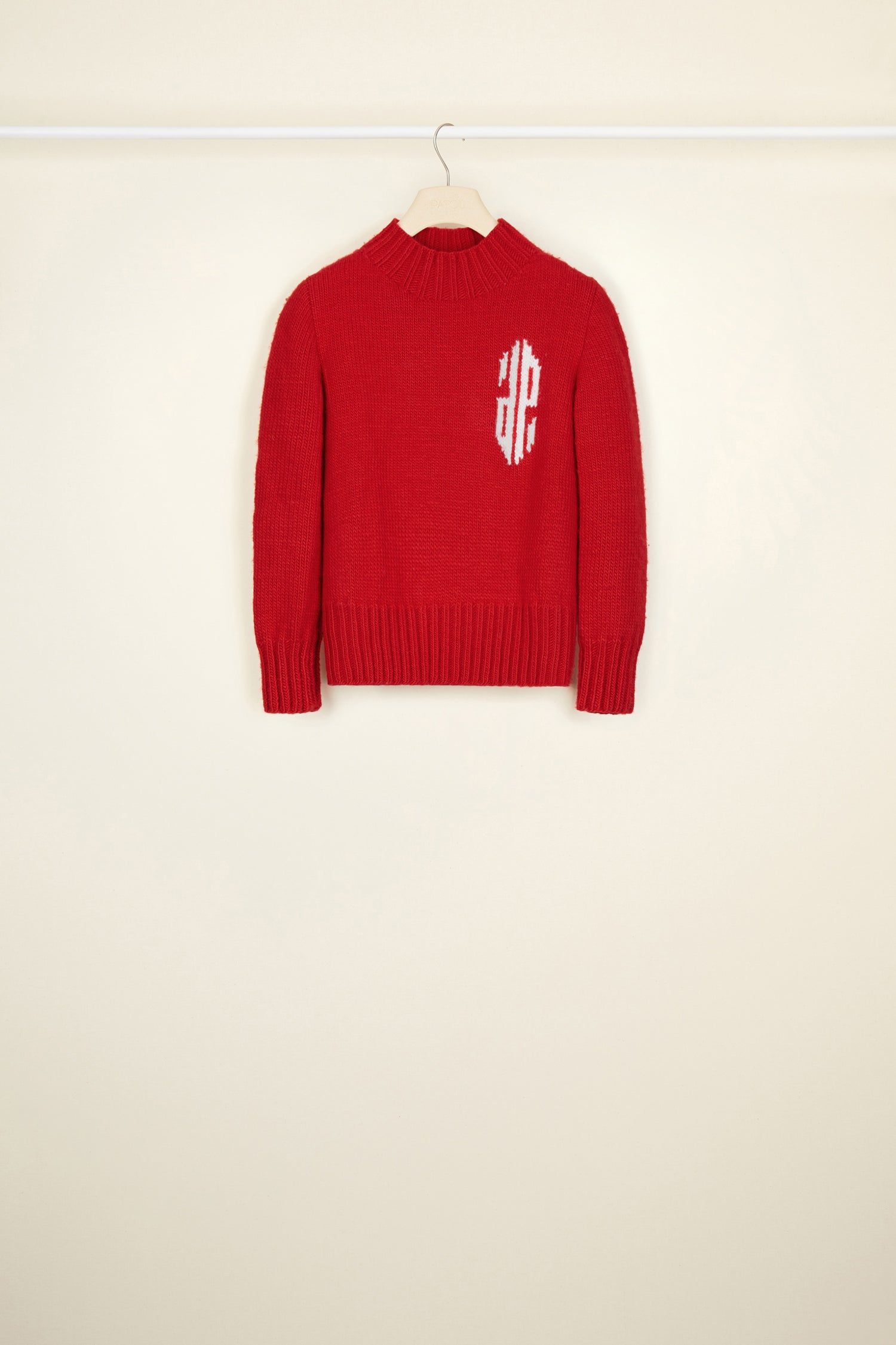 Patou - Cropped intarsia logo jumper - Poppy - A logo, a crest, a declaration of style.Poppy red wool jumper with intarsia logo on the chest in contrasting white. Cropped silhouette with a high neckline. Ribbed collar, cuffs and hem.