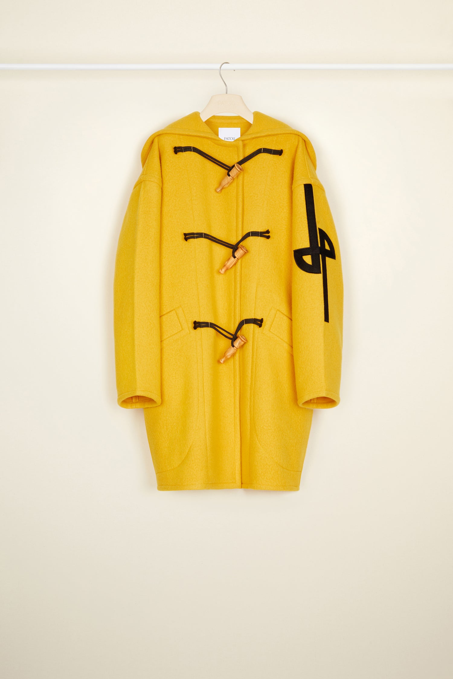 Patou - Duffle coat in eco-friendly wool and cashmere - Saffron - A winter sensation, a Patou revelation! Saffron yellow wool and cashmere duffle coat. Crafted from recycled materials blended to achieve a softly worn look over time. Oversized silhouette. Hooded collar. Fastens via wooden buttons shaped like bird calls as well as concealed press buttons. Stylised JP logo embroidered in black on the left sleeve. Oversized patch pockets.