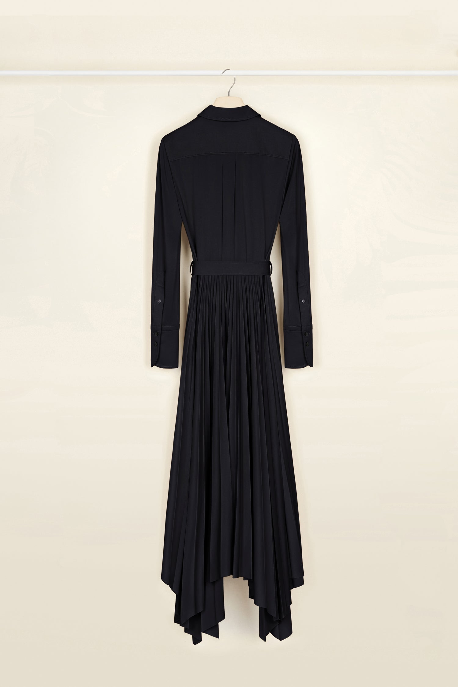 Patou - Maxi pleated shirt dress in eco-friendly jersey - Black - Belted and pleated, a silhouette-defining moment. Black recycled stretch jersey dress. Butterfly collar. Concealed button fastening. Box pleats on the bodice. Fabric belt at the waist. Wide cuffs with embroidered Patou logo and buttons. Asymmetrical maxi skirt with sunpleats.