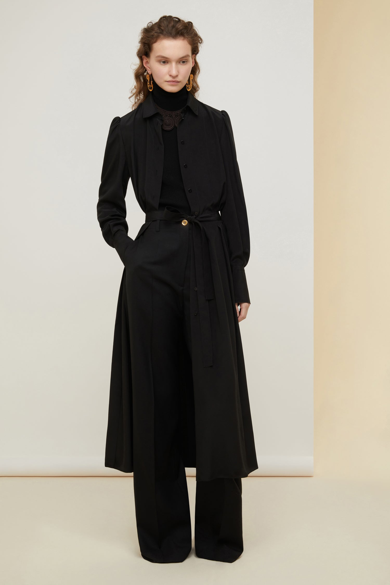 Patou - Pleated silk midi shirt dress - Black - Elongated and pleated, the shirt reinvented. Black silk crepe midi dress. Shirt-inspired silhouette with button fastening down the bodice. Puffed shoulders. Wide buttoned cuffs. Belted at the waist. Pleated skirt.