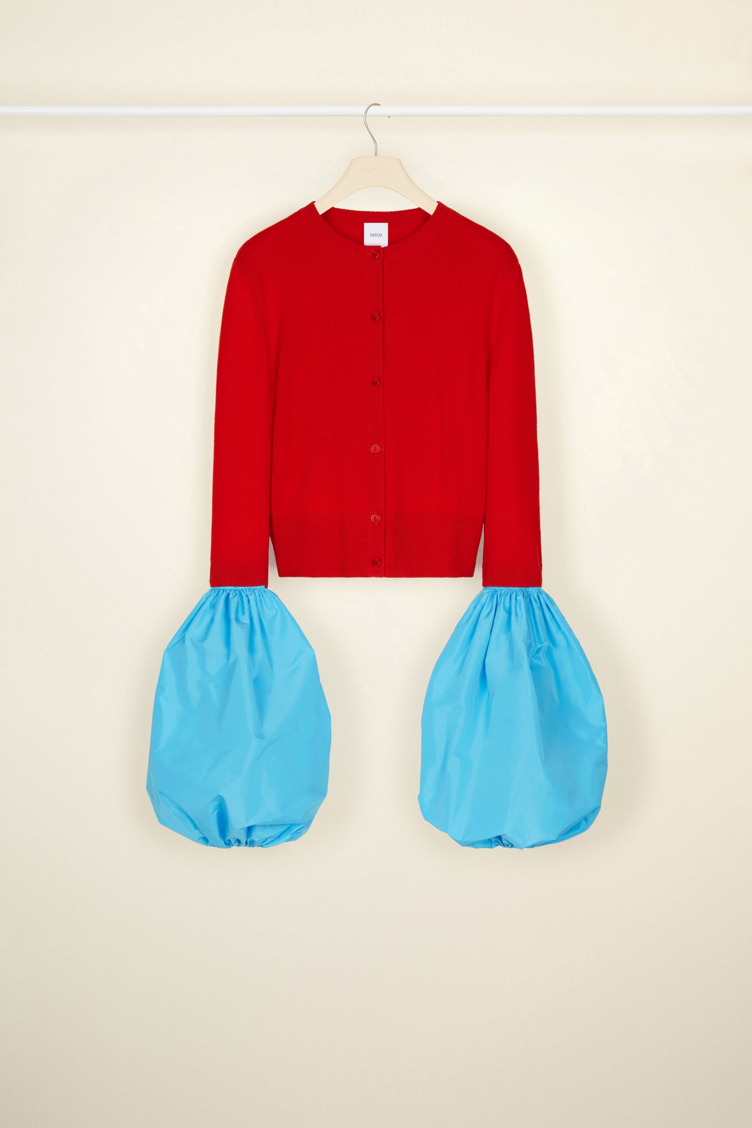 Patou - Cardigan in lana e cachemire con maniche rimovibili - Poppy - Il polsino in primo piano.Cardigan in lana e cachemire rosso papavero. Modello cropped con maniche a tre quarti. Polsini a palloncino rimovibili in faglia riciclata turchese; bordi elasticizzati. Chiusura con bottoni incisi JP.
