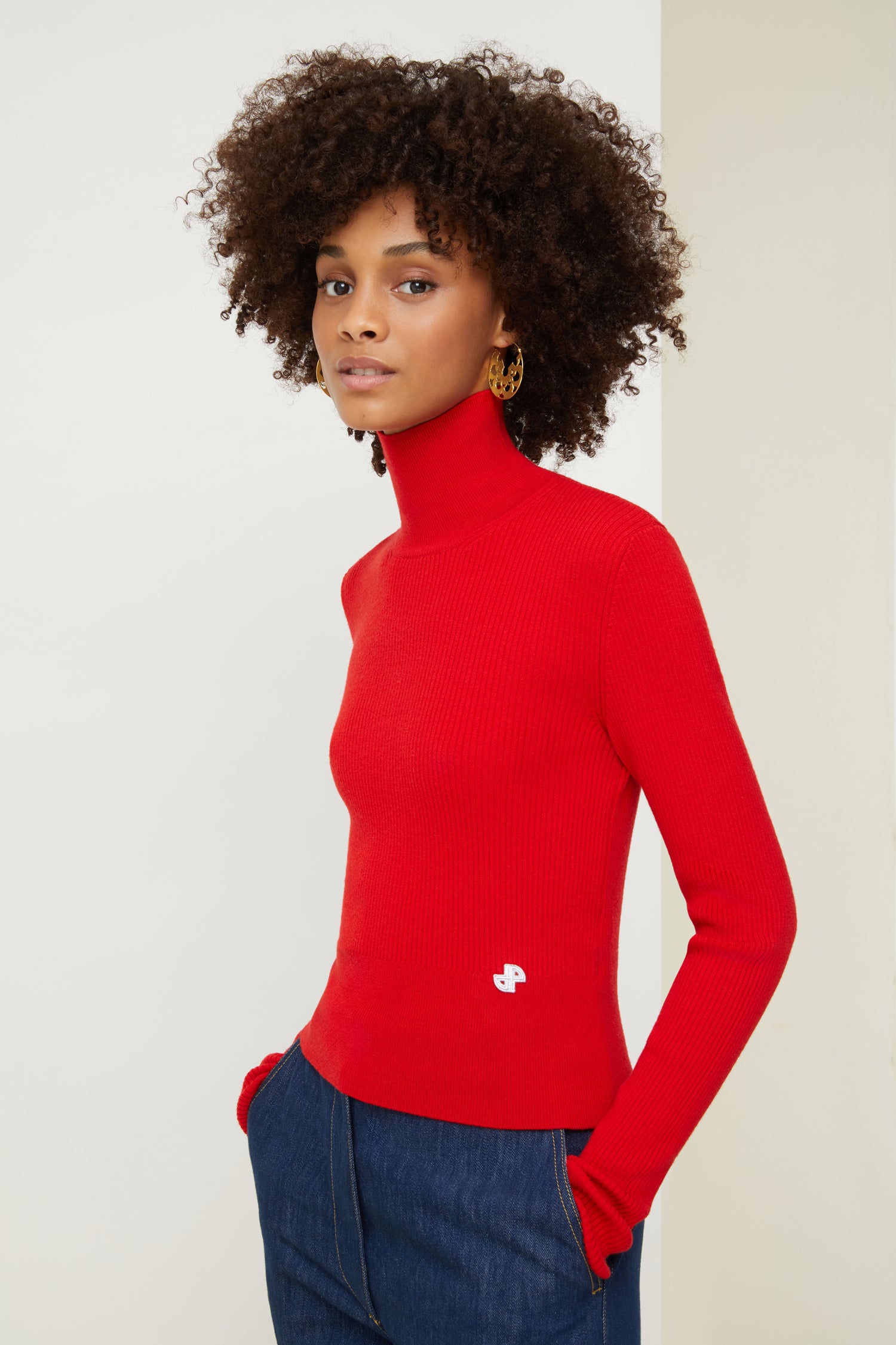 Patou - High neck rib knit jumper - Poppy - The perfect style staple to keep layering chic and simple. Poppy red rib knit jumper. Fitted style with a high neck. Cropped silhouette. Small white JP logo at the front.