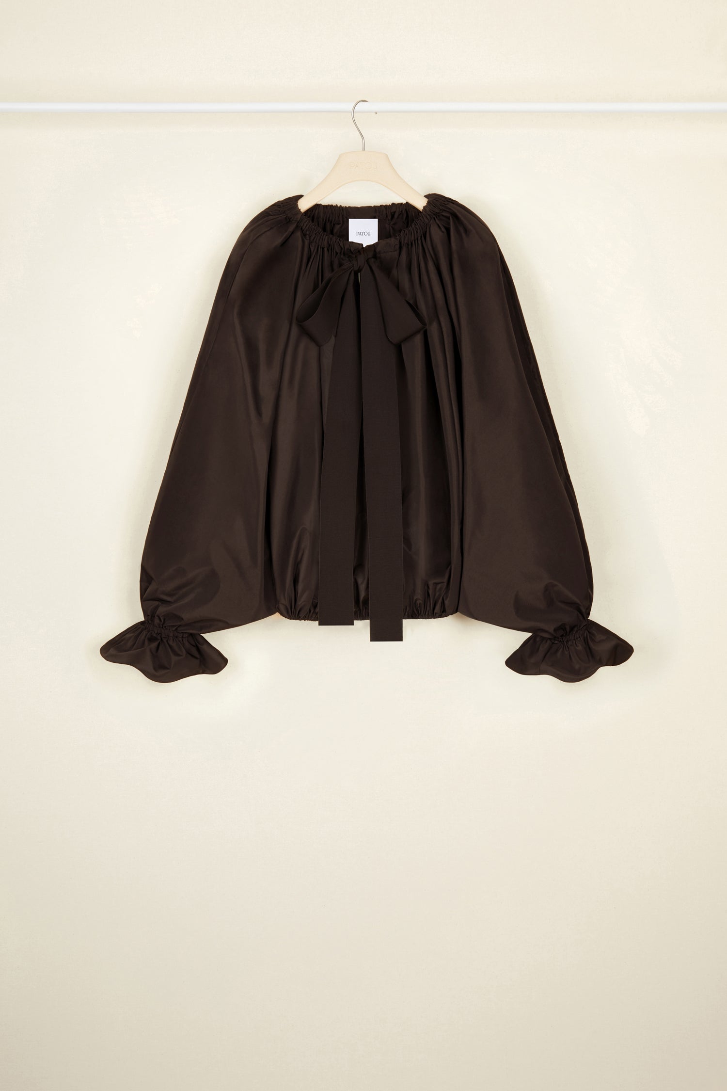 Patou - Top in faglia riciclata con maniche a palloncino - Havana - Collo alto o spalla scoperta? Il top Patou da indossare come decidi tu. Top in faglia riciclata marrone Havana. Vestibilità oversize. Può essere indossato chiuso sul collo o in modo da scoprire le spalle. Collo con dettaglio di balza sul fronte e coulisse in grosgrain. Maniche a pipistrello con polsini elasticizzati. Vita elasticizzata.