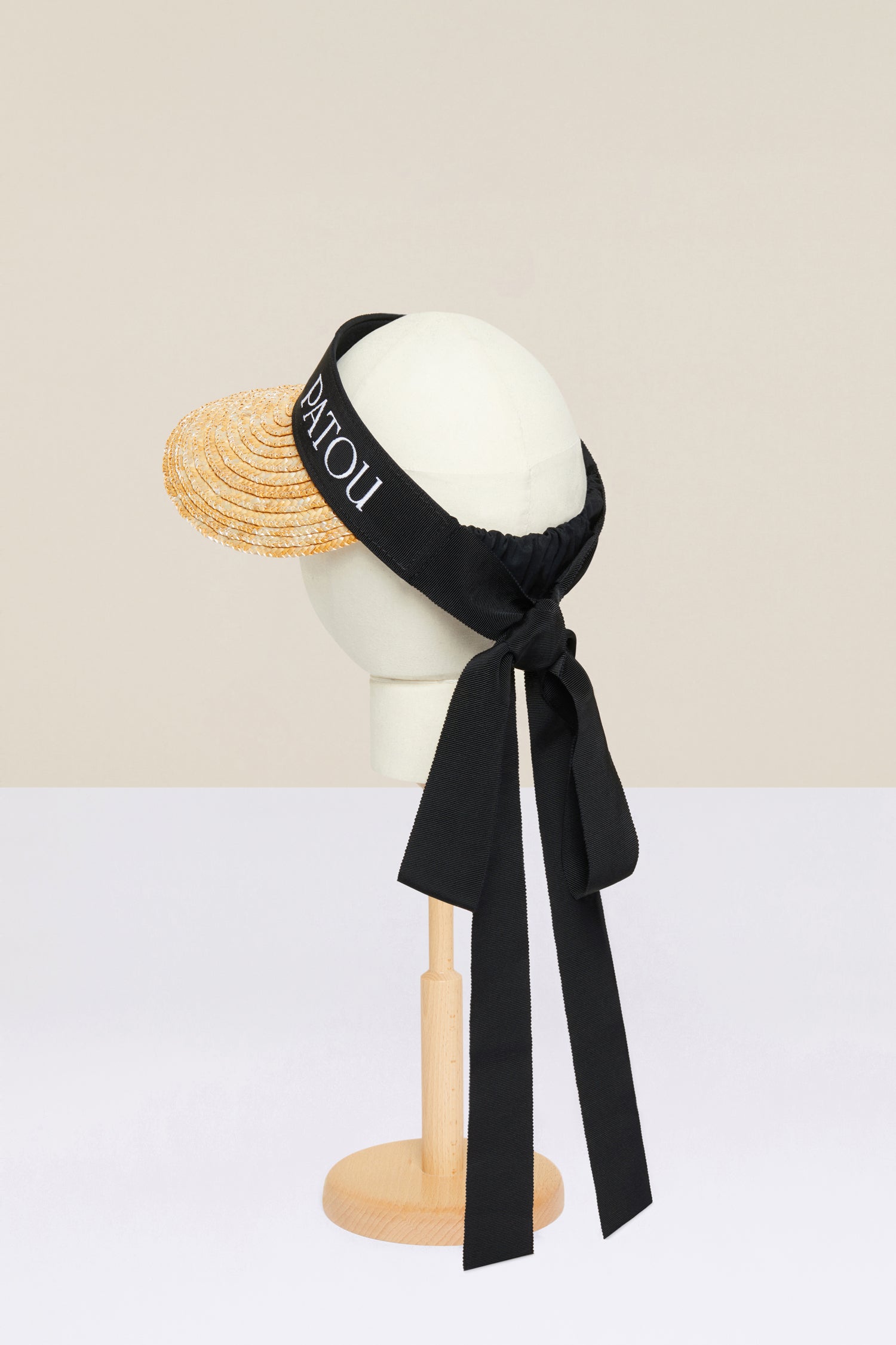Patou - Grosgrain visor hat in wicker - Vanilla - How to dress for a sunny day, the Patou way. Vanilla wicker visor hat. Black grosgrain trim with long ties at the back. Elasticated strap at the back. Patou logo embroidered in white at the front.
