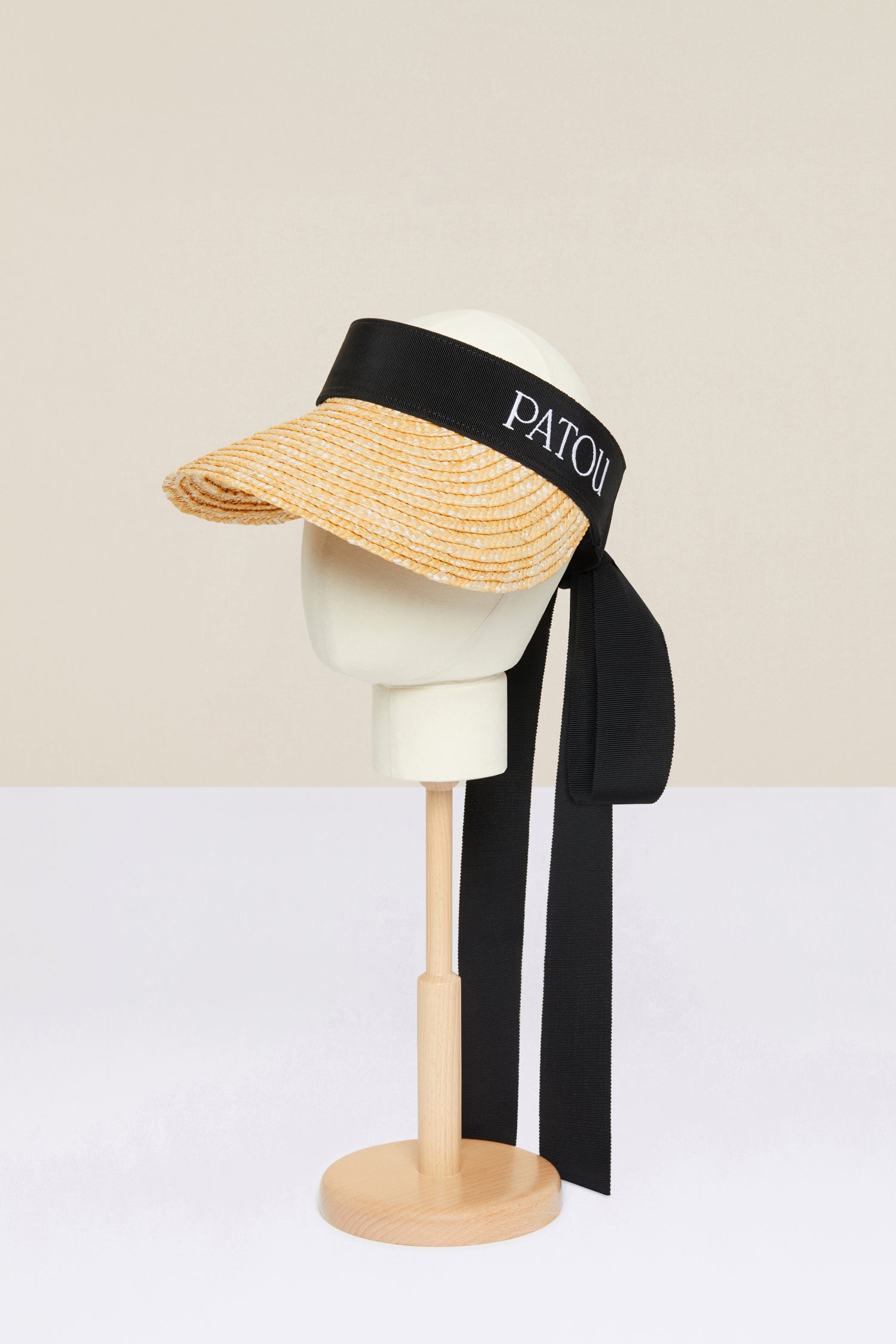 Patou - Grosgrain visor hat in wicker - Vanilla - How to dress for a sunny day, the Patou way. Vanilla wicker visor hat. Black grosgrain trim with long ties at the back. Elasticated strap at the back. Patou logo embroidered in white at the front.