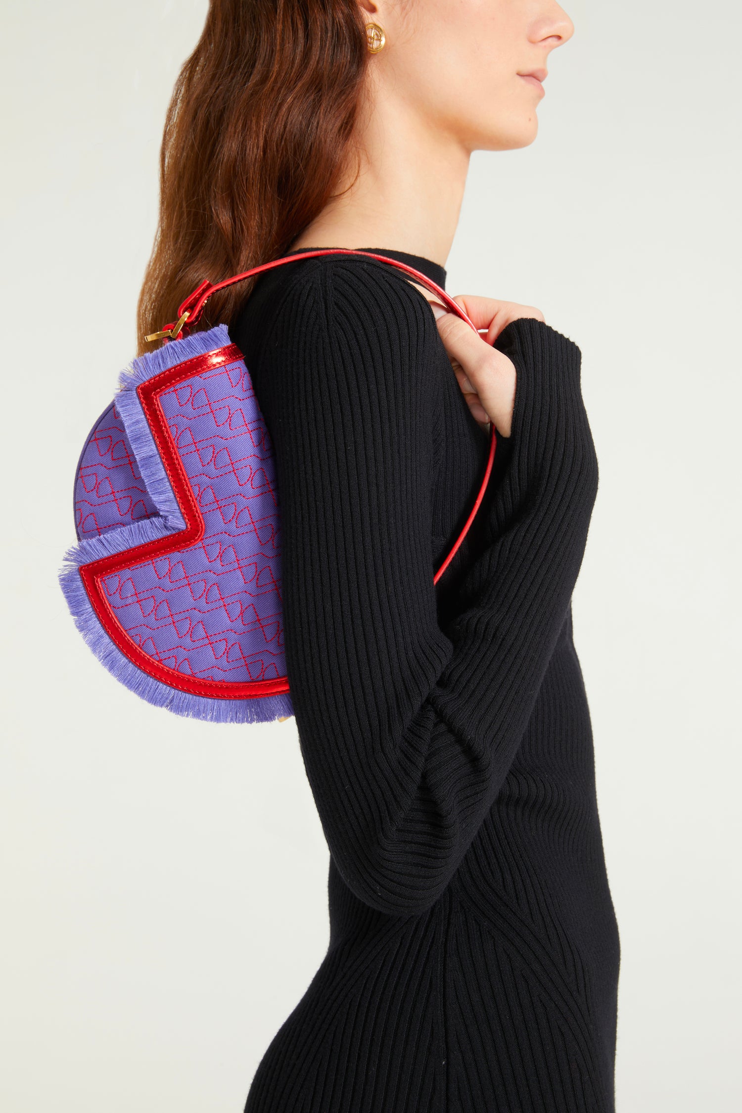 Patou - Le Petit Patou x Sita - Purple Blue Red - A high-octane remix on a Patou favouriteViolet denim-effect recycled organic cotton and red metallic leather handbag. Part of a special collaboration with DJ and designer Sita Abellán. Crafted using premium deadstock leather. Half-circle shape with geometric cut-outs inspired by the JP monogram. Allover JP quilting in red. Gold-tone hardware with Patou-engraved detail at the side. Leather outline with fringed edges. Removable leather strap adorned with Sita's signature snake that allows it to be worn on the shoulder or carried by hand. Might be replaced by a gold-tone brass chain strap (sold separately) adorned with Patou letter charms and Sita's snake symbol; the chain can be used as single or double length and worn on the shoulder, across the body or at the waist to turn Le Petit Patou into a belt bag. Magnetic closure with gold-tone JP detail. Internal compartment. Eco lining.Measures: 20cm (length), 13cm (height), 5cm (depth)