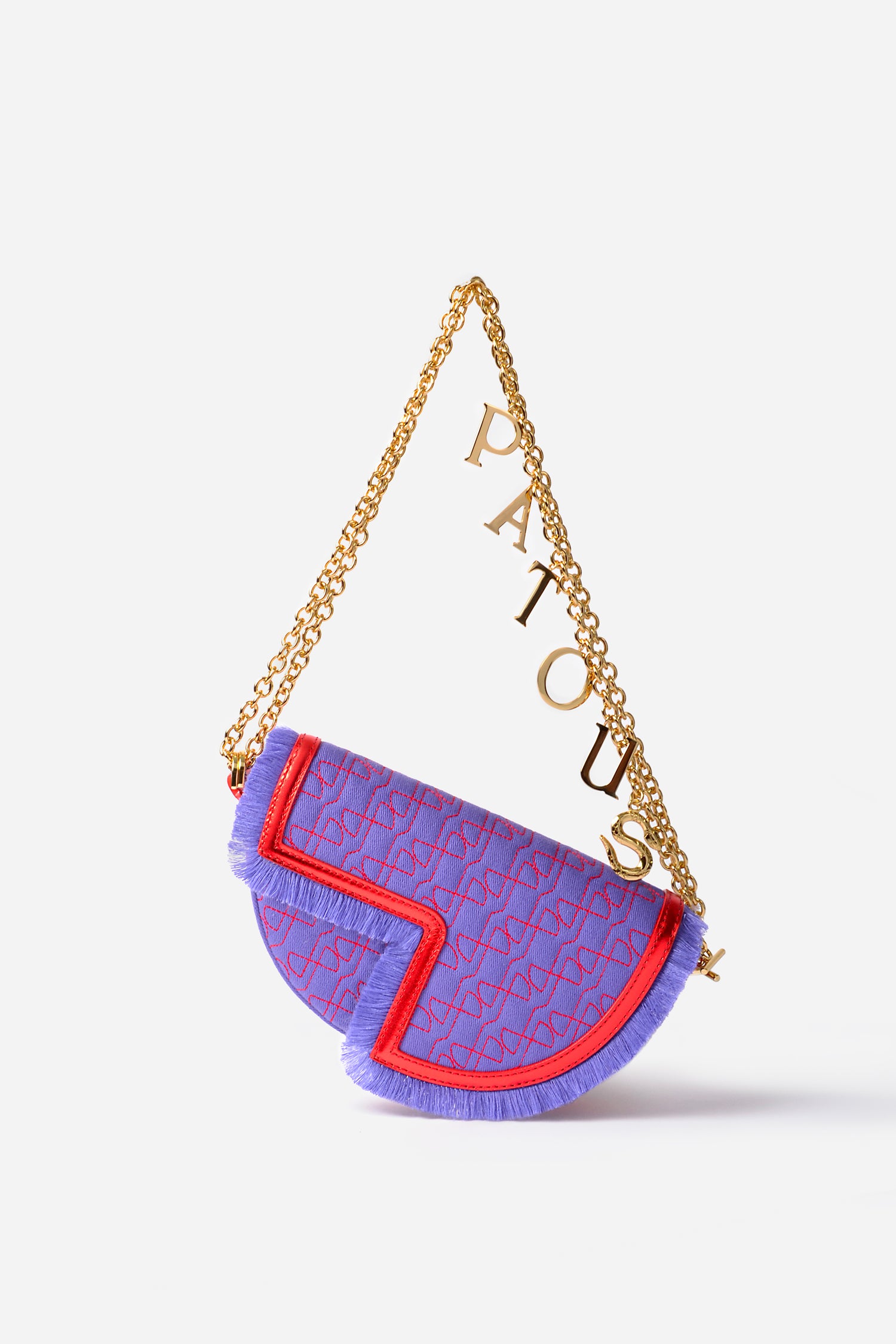 Patou - Le Petit Patou x Sita - Purple Blue Red - A high-octane remix on a Patou favouriteViolet denim-effect recycled organic cotton and red metallic leather handbag. Part of a special collaboration with DJ and designer Sita Abellán. Crafted using premium deadstock leather. Half-circle shape with geometric cut-outs inspired by the JP monogram. Allover JP quilting in red. Gold-tone hardware with Patou-engraved detail at the side. Leather outline with fringed edges. Removable leather strap adorned with Sita's signature snake that allows it to be worn on the shoulder or carried by hand. Might be replaced by a gold-tone brass chain strap (sold separately) adorned with Patou letter charms and Sita's snake symbol; the chain can be used as single or double length and worn on the shoulder, across the body or at the waist to turn Le Petit Patou into a belt bag. Magnetic closure with gold-tone JP detail. Internal compartment. Eco lining.Measures: 20cm (length), 13cm (height), 5cm (depth)