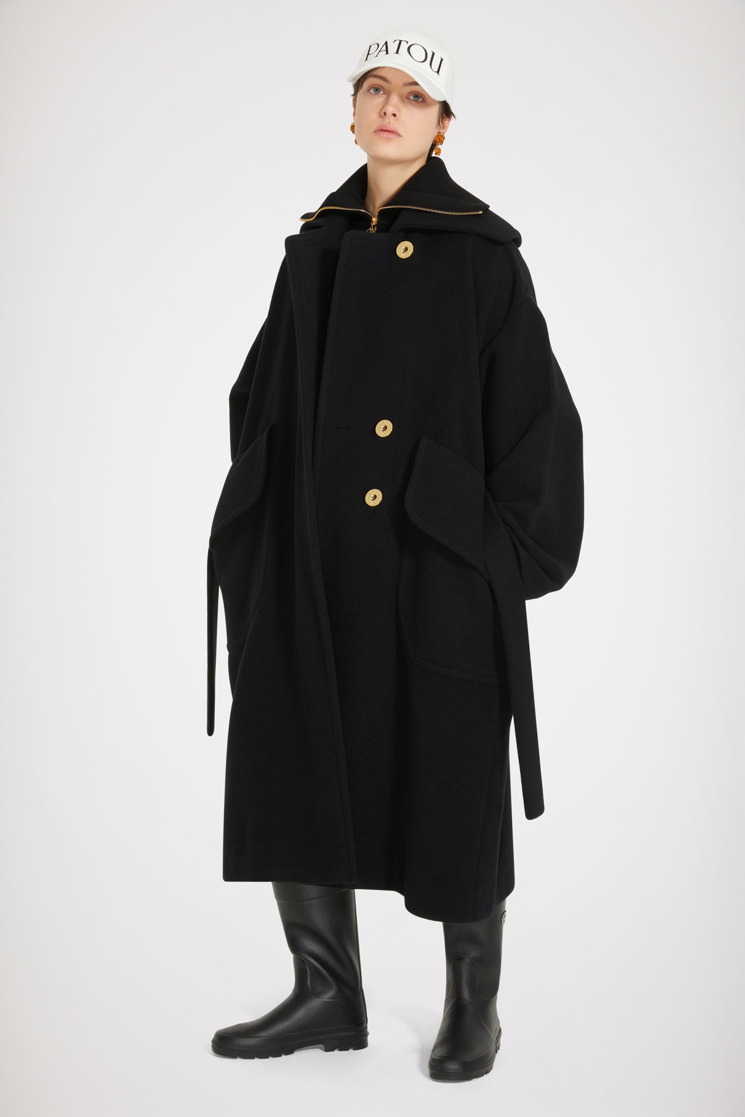 Patou - Maxi coat in double-faced wool - Black - Triple cheers for Patou's double-faced sensation! Black double-faced wool coat. High-volume silhouette. Single-breasted design with off-centre button fastening at the front. Patou-engraved gold-tone buttons. Wide sailor-style collar with embroidered Patou logo at the back. Self-tie belt at the waist. Oversized flap pockets. Loose fit (select one size down for a fitted look).