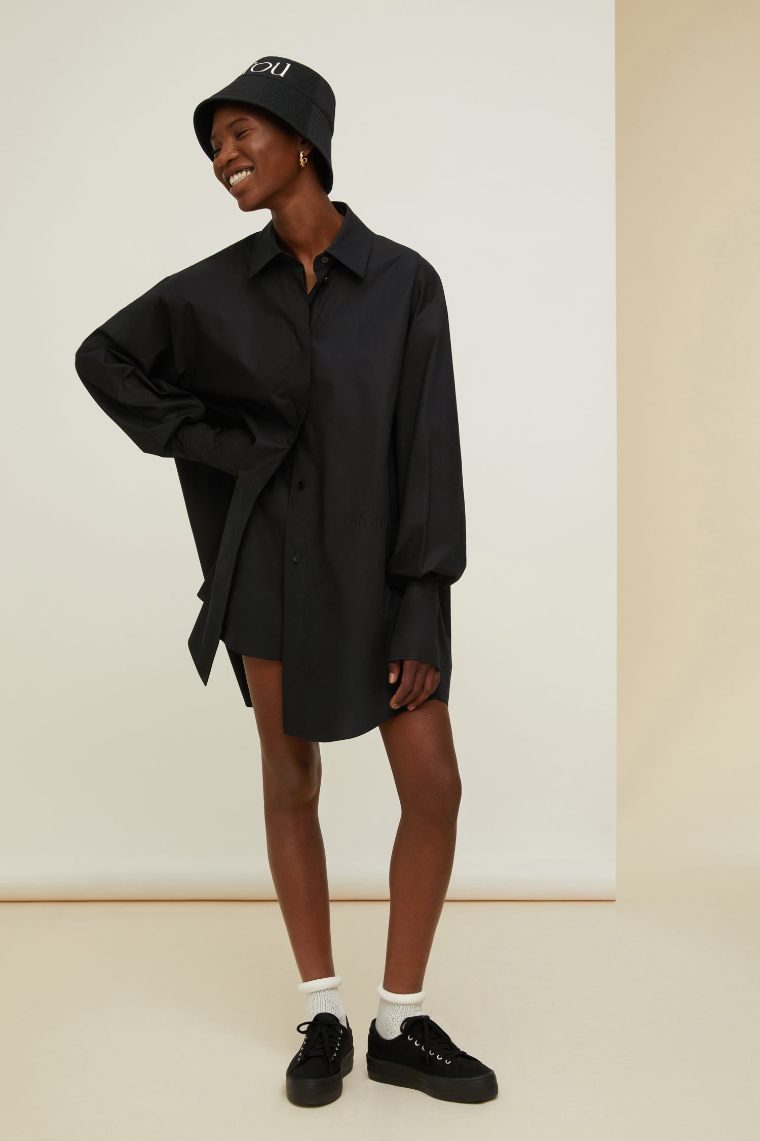 Patou - Mini shirt dress in organic cotton - Black - Layered or on its own, a new shape to make your own.Black organic cotton poplin shirt dress. Short length. Loose silhouette. Shirt collar. Concealed button fastening with JP engraved buttons. Patou logo embroidered at the front. Signature curved seam at the back. Buttoned cuffs.