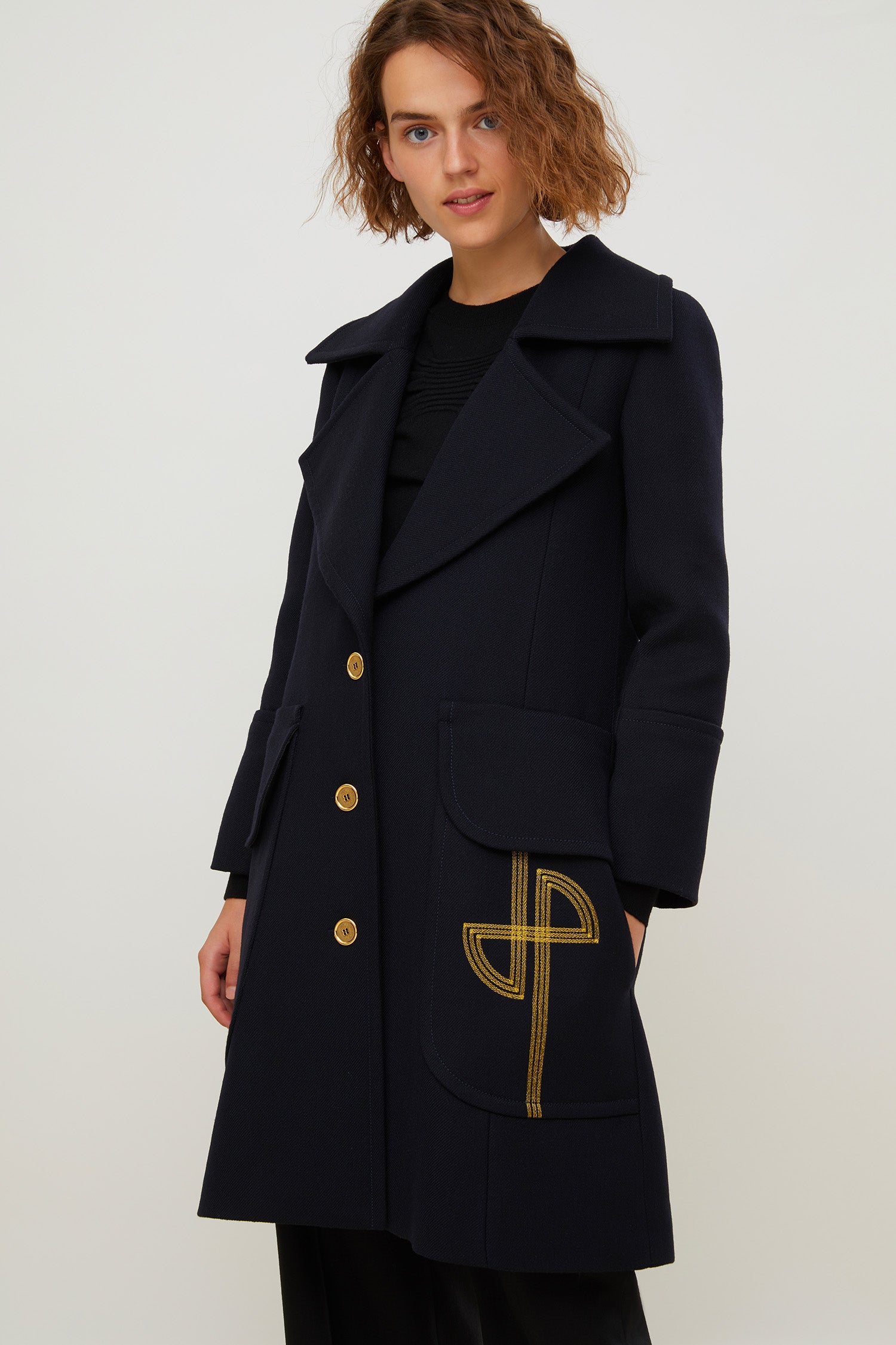 Patou - Longline wool coat with embroidered logo - Navy - Patou puts its stamp on the overcoat.Navy virgin wool longline coat with exaggerated lapels. Gold-coloured buttons and gold embroidered logo at the front. Cuffed sleeves and flap pockets. Fully lined.