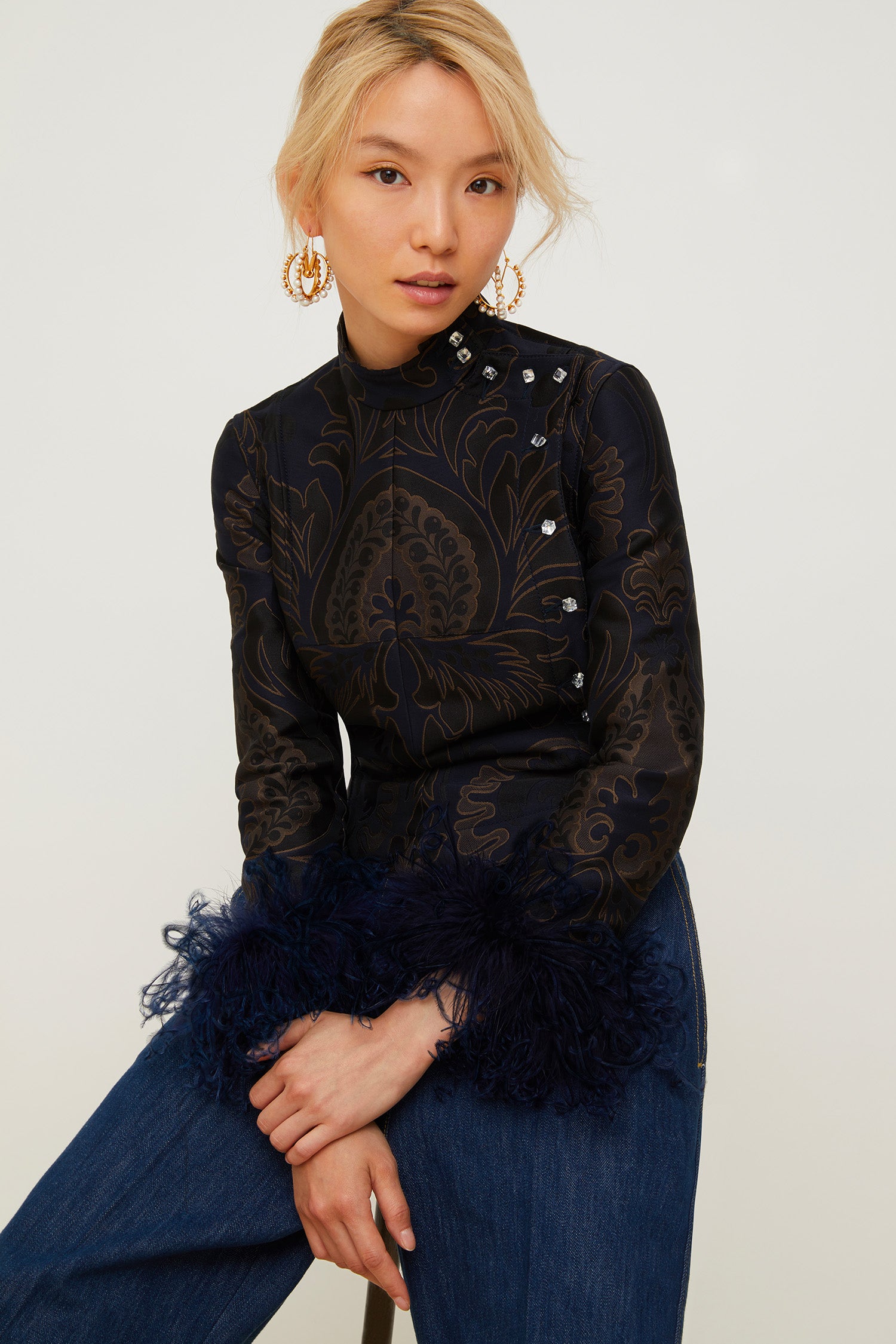 Patou - Feather-embellished silk brocade jacket - Navy Amber Print - Brocade is timeless, feathers are forever!Cropped navy and amber silk brocade jacket inspired by fencing uniforms. High collar and bejewelled buttons at the side. Removable ostrich feathers at the cuffs. Self-tie martingale at the back.