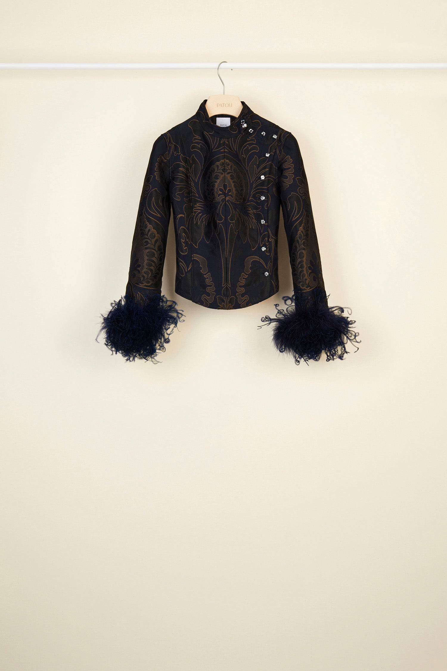 Patou - Feather-embellished silk brocade jacket - Navy Amber Print - Brocade is timeless, feathers are forever!Cropped navy and amber silk brocade jacket inspired by fencing uniforms. High collar and bejewelled buttons at the side. Removable ostrich feathers at the cuffs. Self-tie martingale at the back.