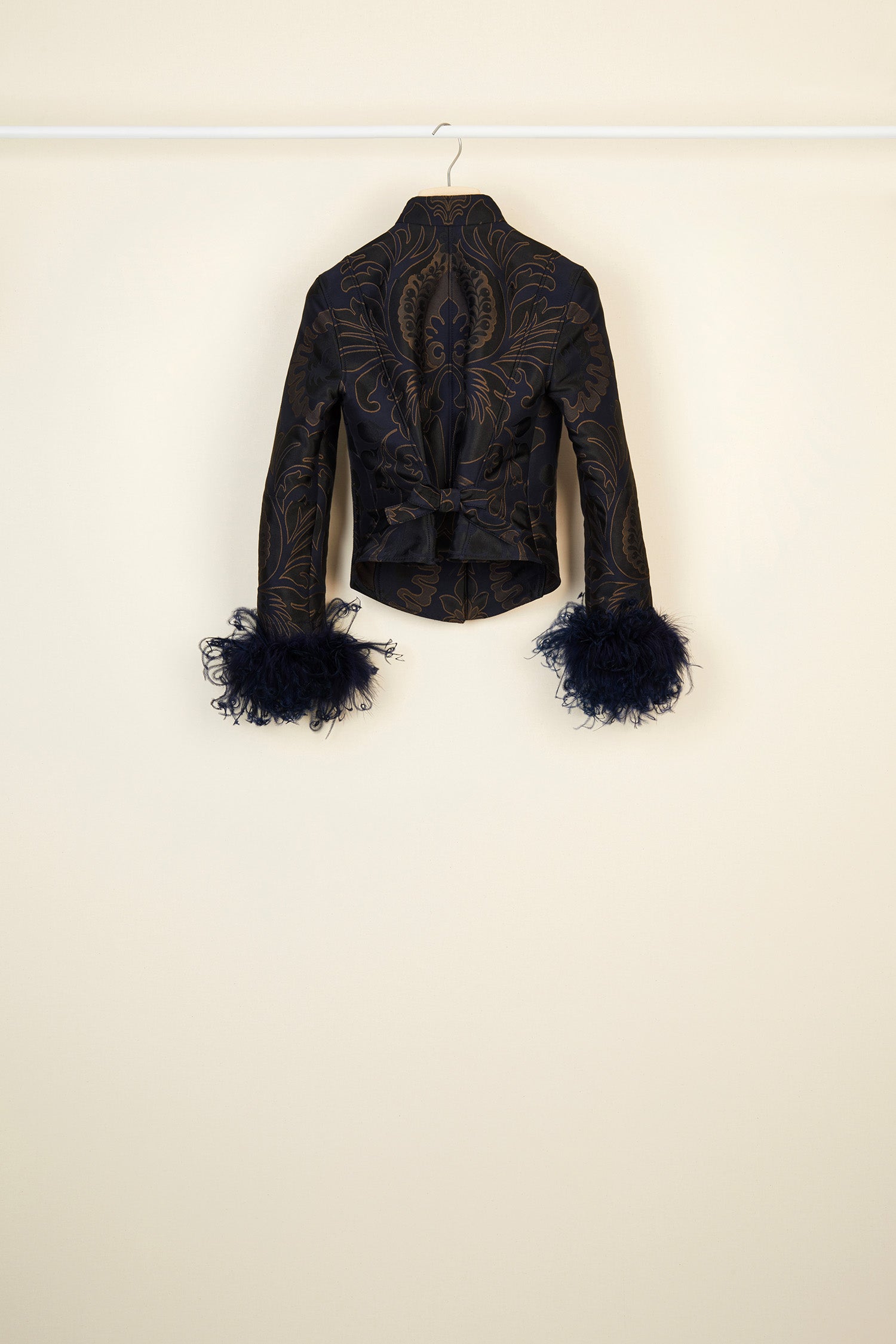 Patou - Feather-embellished silk brocade jacket - Navy Amber Print - Brocade is timeless, feathers are forever!Cropped navy and amber silk brocade jacket inspired by fencing uniforms. High collar and bejewelled buttons at the side. Removable ostrich feathers at the cuffs. Self-tie martingale at the back.