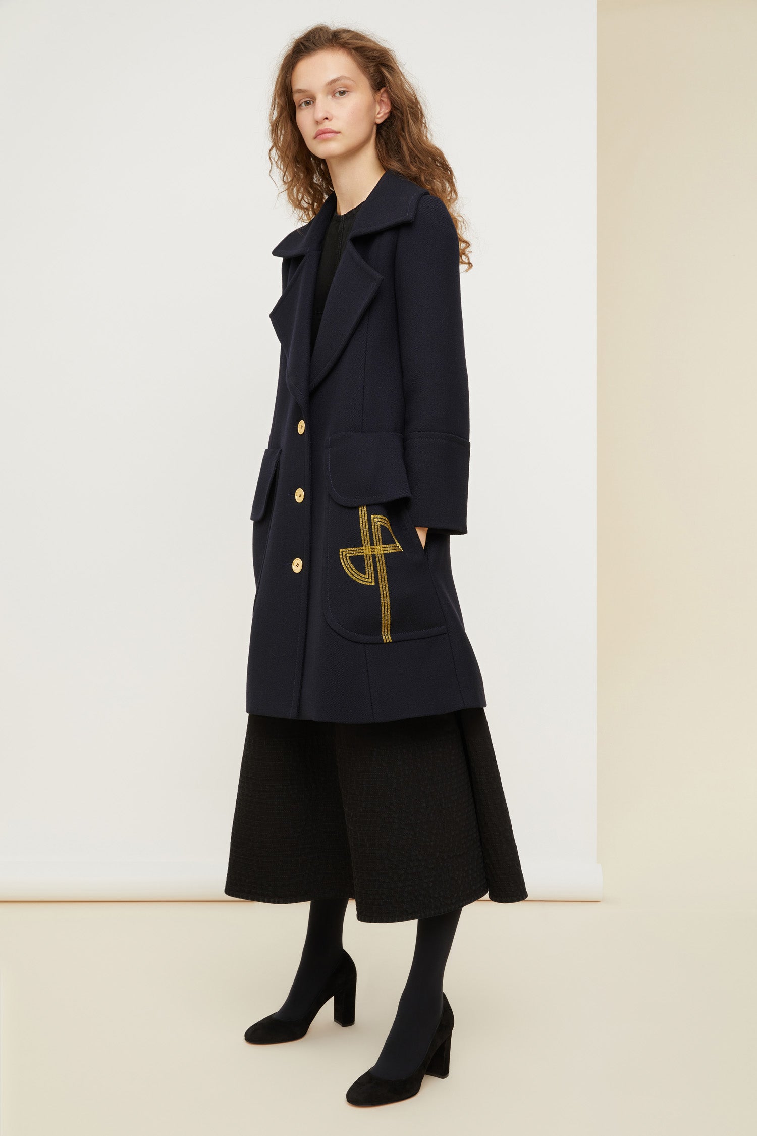 Patou - Longline wool coat with embroidered logo - Navy - Patou puts its stamp on the overcoat.Navy virgin wool longline coat with exaggerated lapels. Gold-coloured buttons and gold embroidered logo at the front. Cuffed sleeves and flap pockets. Fully lined.