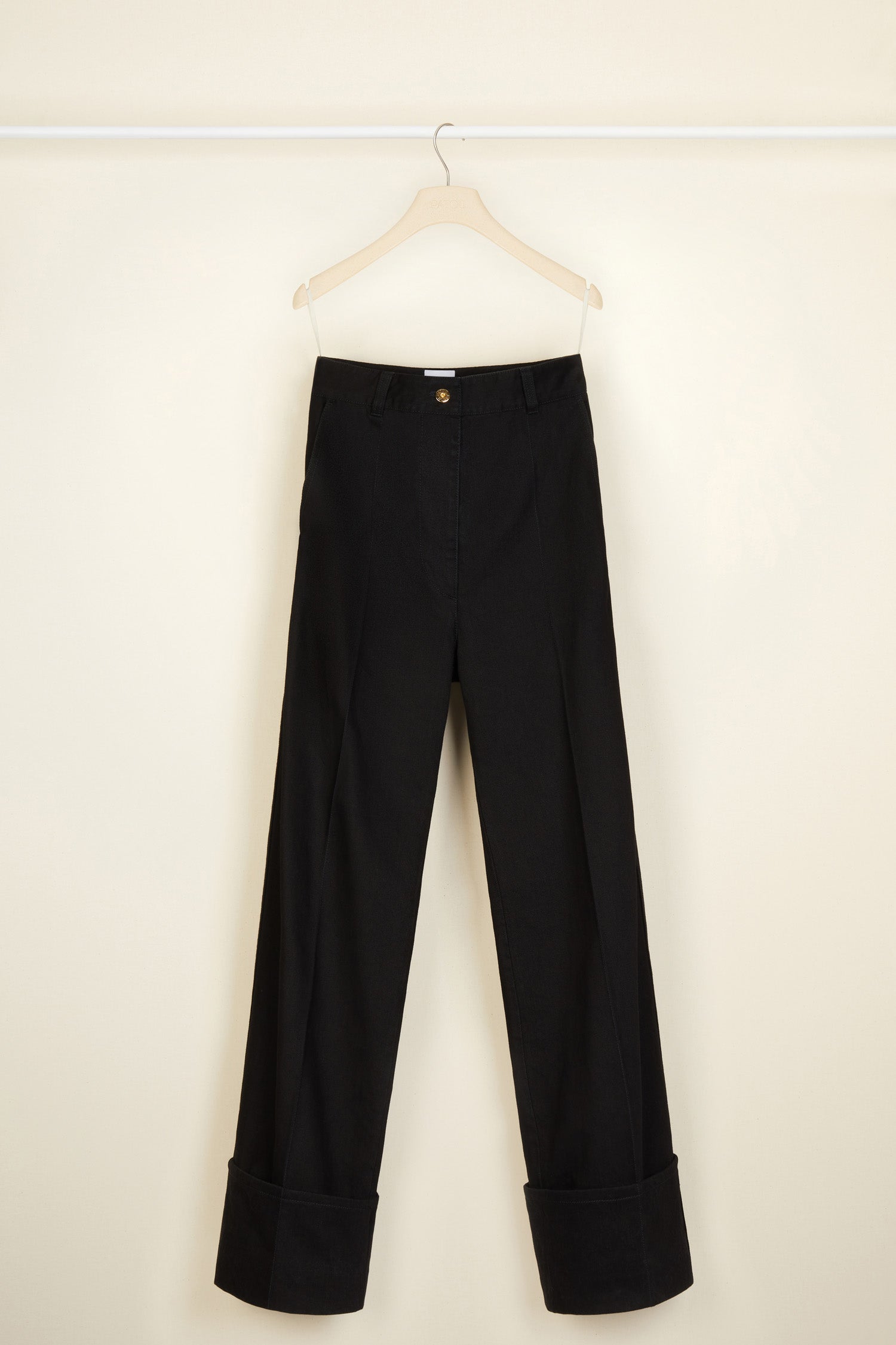 Patou - Cuffed wide-leg trousers in organic denim - Black - Cuffed and loose: denim elevated by Patou. Black organic denim trousers. Wide-legged style. Button fastening with belt loops. Pockets at the sides. Signature curved seam at the back. Wide cuffs.