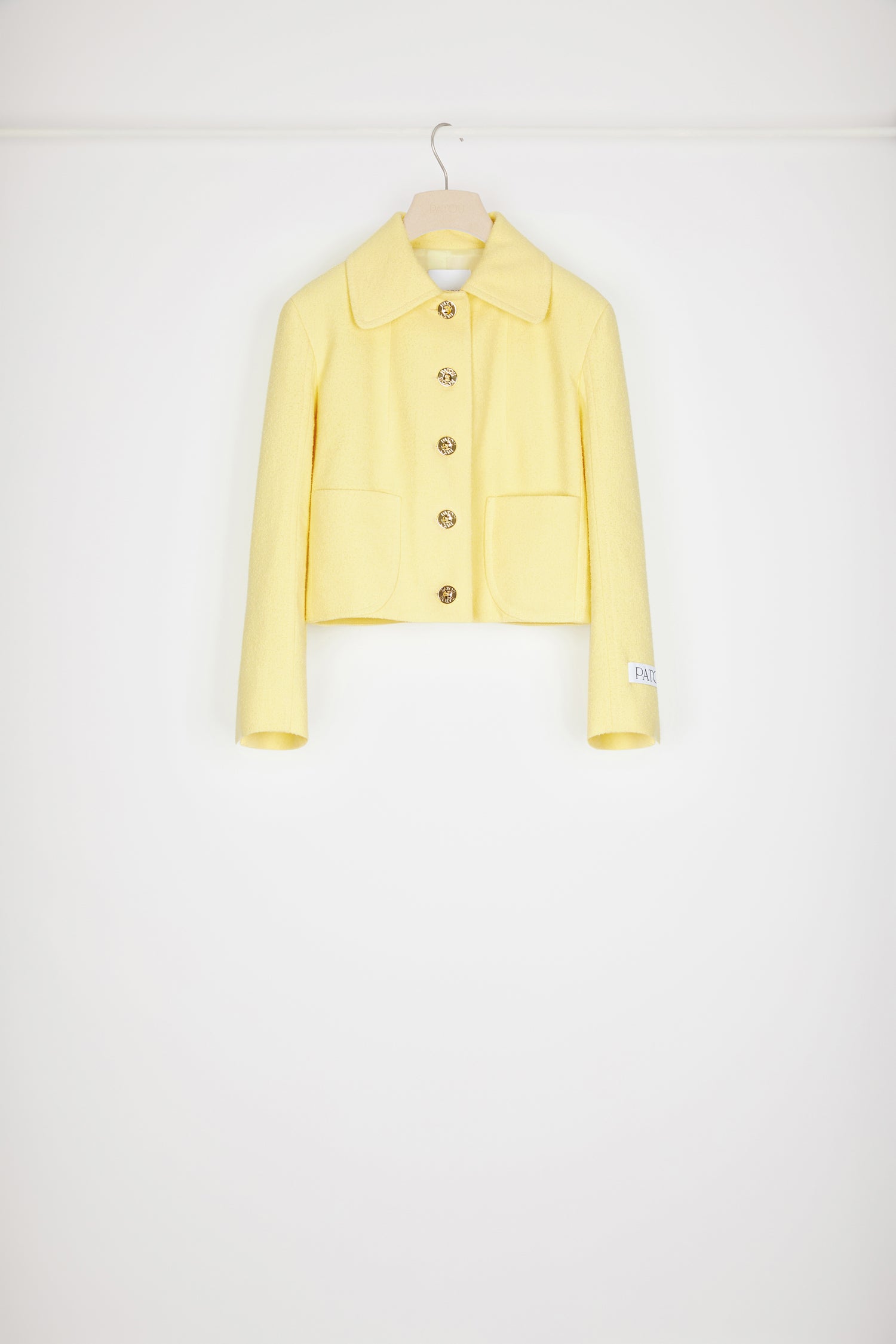 Patou - Short tailored jacket in cotton-blend tweed - Mimosa - Tailored to Patou perfection. Mimosa yellow cotton-blend tweed jacket. Cropped silhouette. Wide collar. Button fastening at the front with gold-tone Patou-engraved buttons. Patch pockets at the front. Patou label on the left sleeve. Split cuffs. Fully lined.Spring-Summer 2023 Show - Look #19