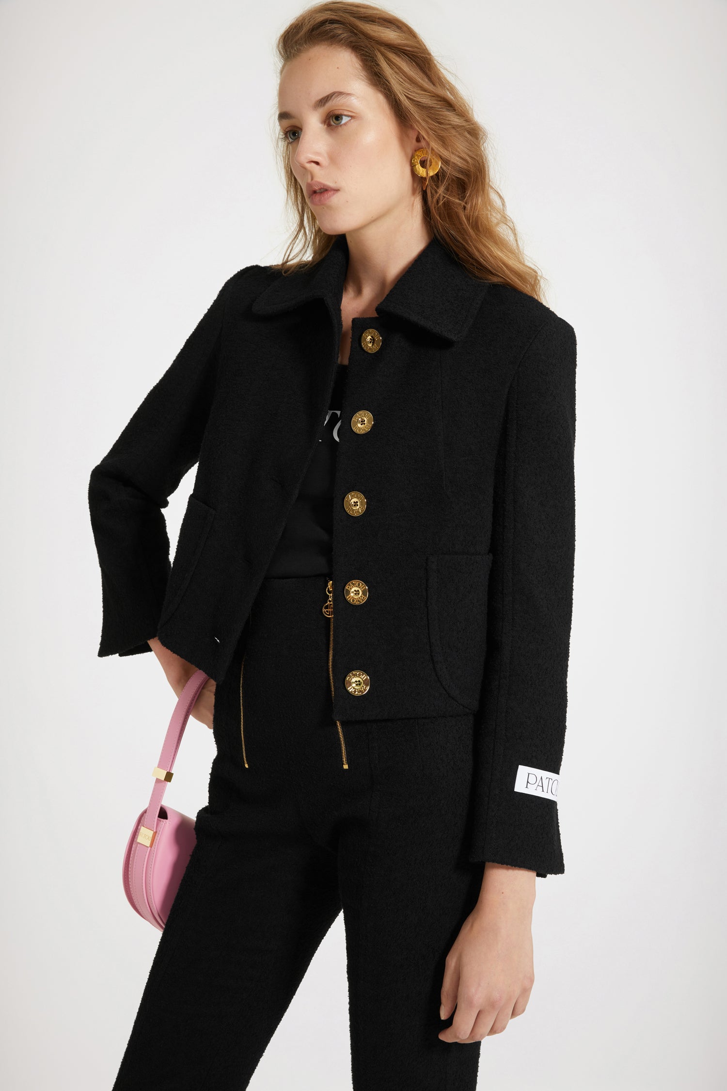 Patou - Short tailored jacket in cotton-blend tweed - Black - Tailored to Patou perfection. Black cotton-blend tweed jacket. Cropped silhouette. Wide collar. Button fastening at the front with gold-tone Patou-engraved buttons. Patch pockets at the front. Patou label on the left sleeve. Split cuffs. Fully lined.Spring-Summer 2023 Show - Look #02