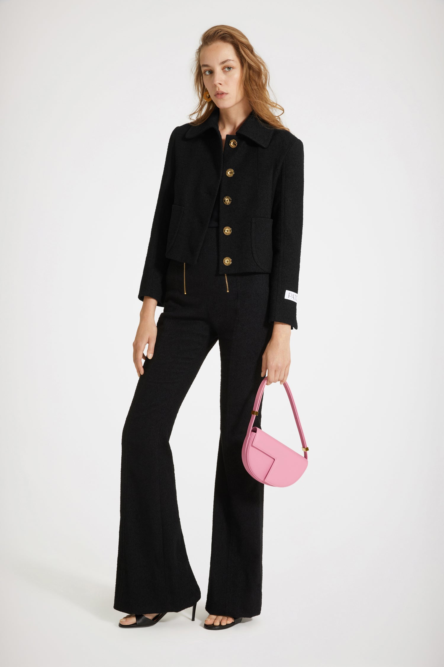 Patou - Short tailored jacket in cotton-blend tweed - Black - Tailored to Patou perfection. Black cotton-blend tweed jacket. Cropped silhouette. Wide collar. Button fastening at the front with gold-tone Patou-engraved buttons. Patch pockets at the front. Patou label on the left sleeve. Split cuffs. Fully lined.Spring-Summer 2023 Show - Look #02