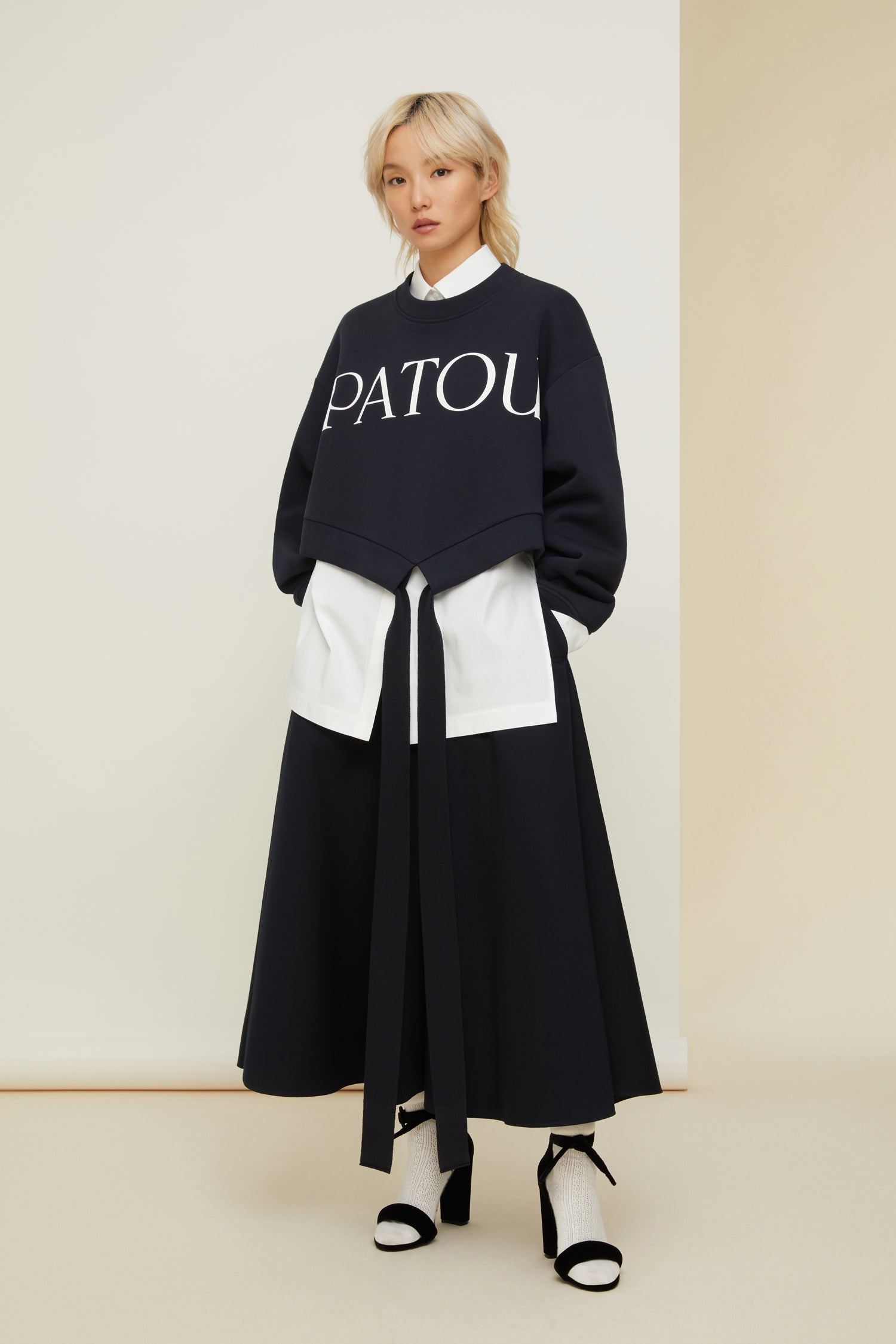 Patou - Cropped grosgrain sweatshirt in organic cotton - Navy Black - Comfort with a side of couture: the sweatshirt by Patou.Navy Black organic cotton sweatshirt. Loose cropped silhouette. Crewneck. Rib knit collar and cuffs. Oversized Patou lettering logo in white across the front. Drawstring waistband with long grosgrain ties.