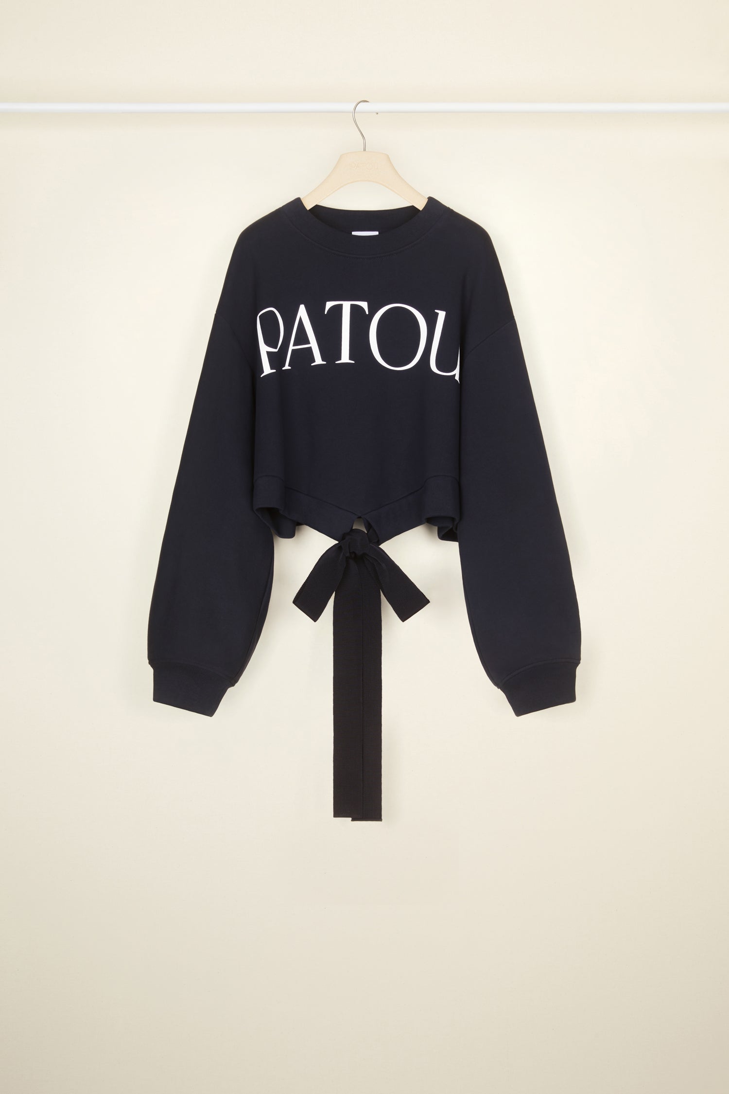 Patou - Cropped grosgrain sweatshirt in organic cotton - Navy Black - Comfort with a side of couture: the sweatshirt by Patou.Navy Black organic cotton sweatshirt. Loose cropped silhouette. Crewneck. Rib knit collar and cuffs. Oversized Patou lettering logo in white across the front. Drawstring waistband with long grosgrain ties.