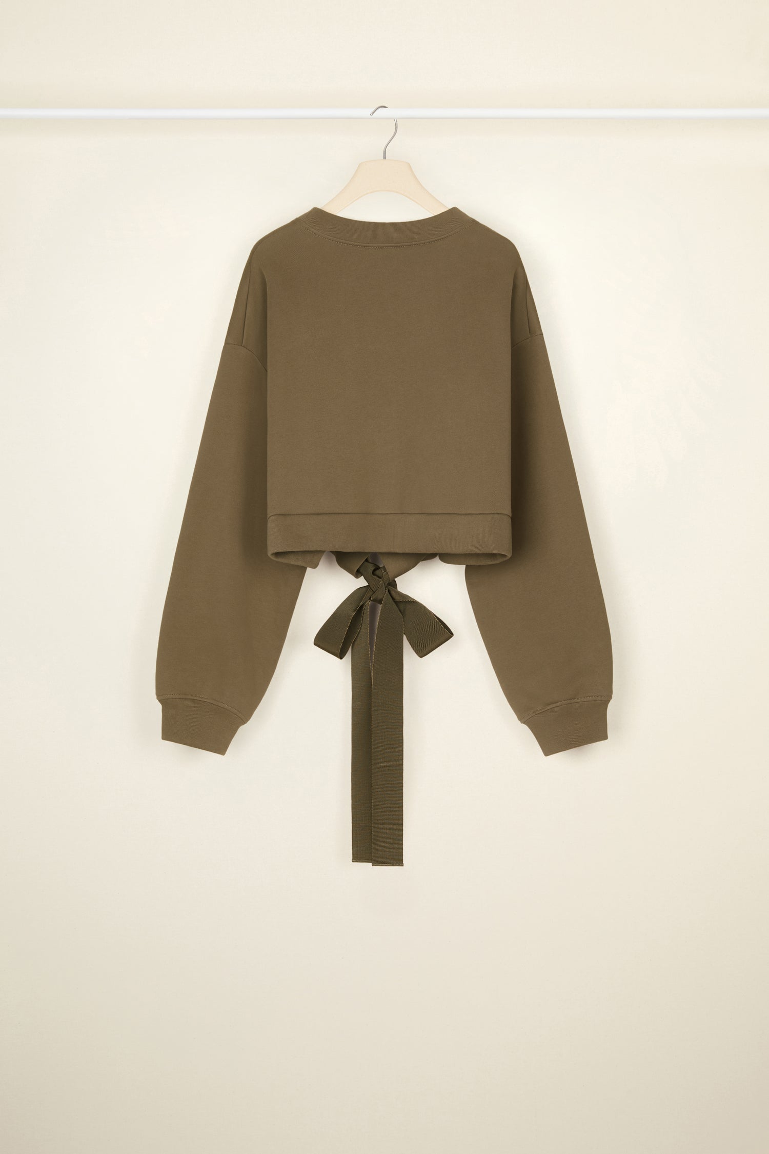 Patou - Cropped grosgrain sweatshirt in organic cotton - Bronze - Comfort with a side of couture: the sweatshirt by Patou.Bronze organic cotton sweatshirt. Loose cropped silhouette. Crewneck. Rib knit collar and cuffs. Oversized Patou lettering logo in black across the front. Drawstring waistband with long grosgrain ties.
