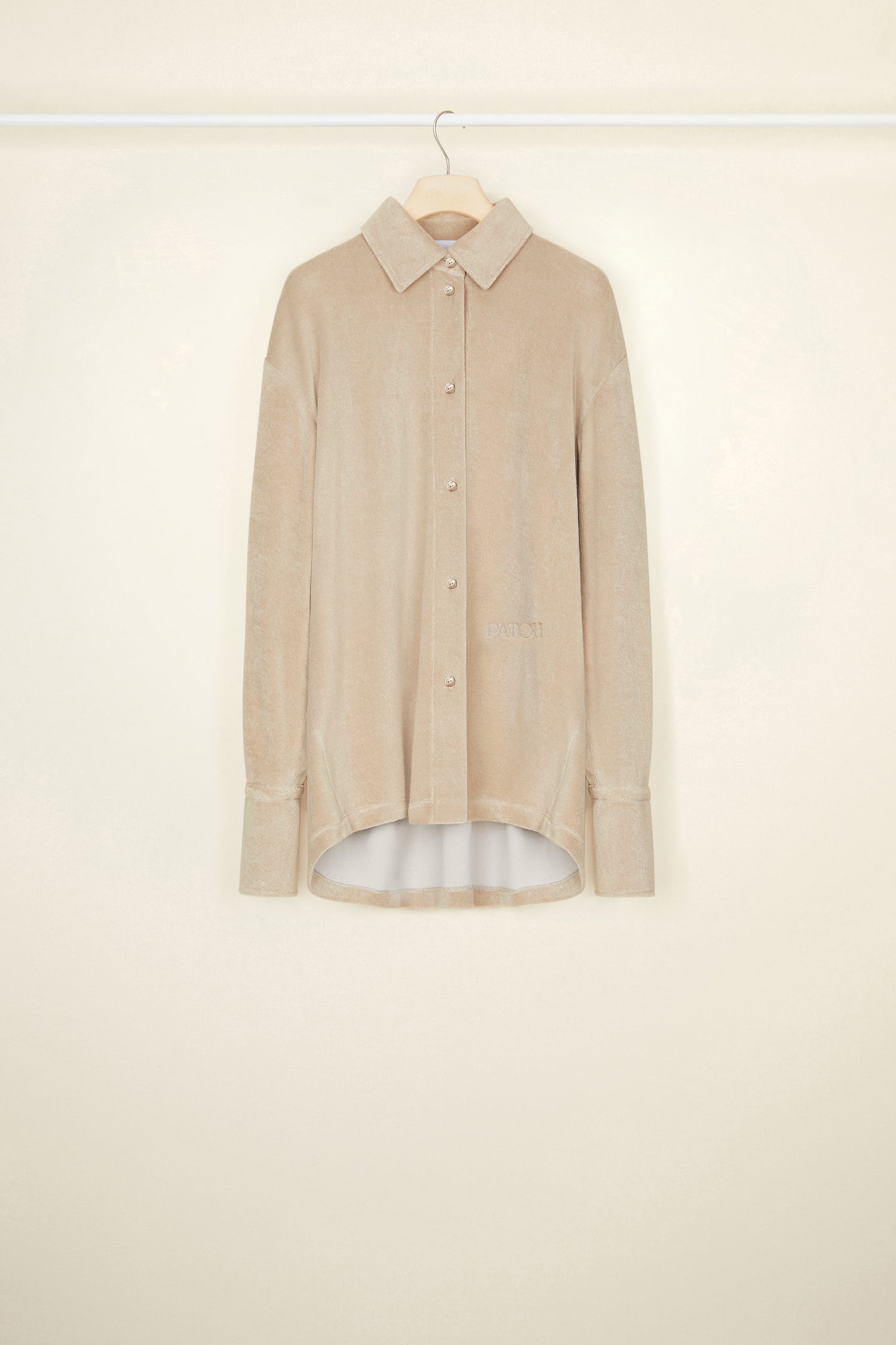 Patou - Oversized terry shirt in organic cotton blend - Parchment - Smile harder, dress softer.Parchment beige terry shirt in organic cotton blend. Loose longline silhouette. Shirt collar. Button fastening with JP engraved buttons at the front. Signature curved seam and knife pleats at the back. Long sleeves with volume at the cuffs.